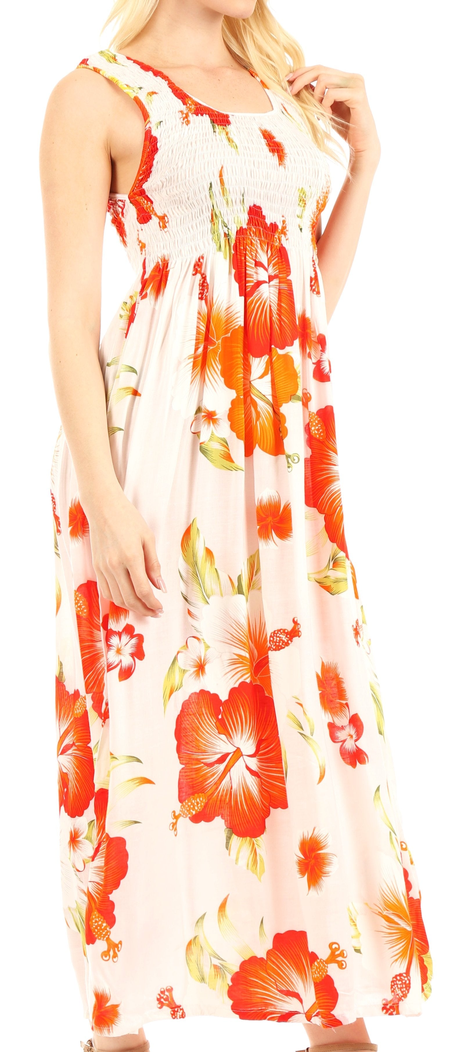 Woman wearing a floral maxi dress with orange and red flowers on a white background