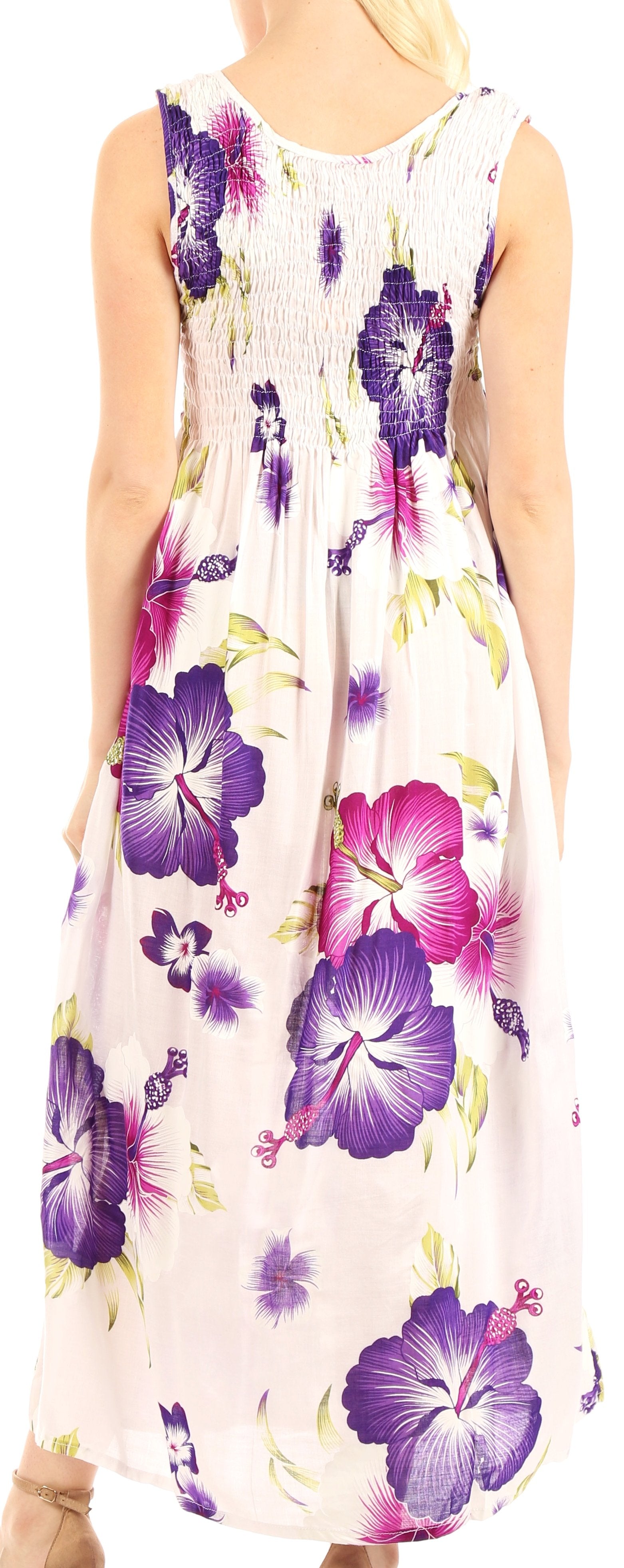 Woman wearing a floral dress with purple and pink flowers on a white background