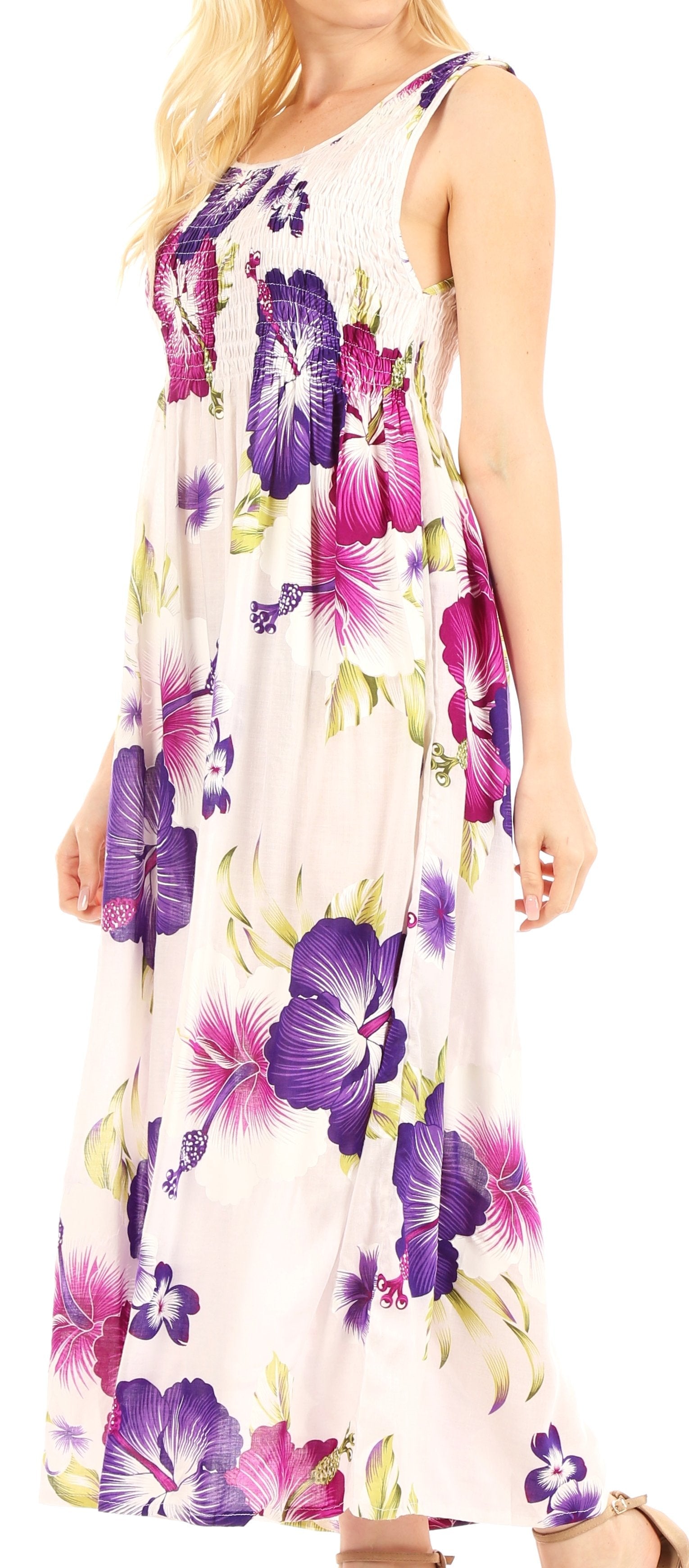 Woman wearing a floral dress with purple and yellow flowers on a white background