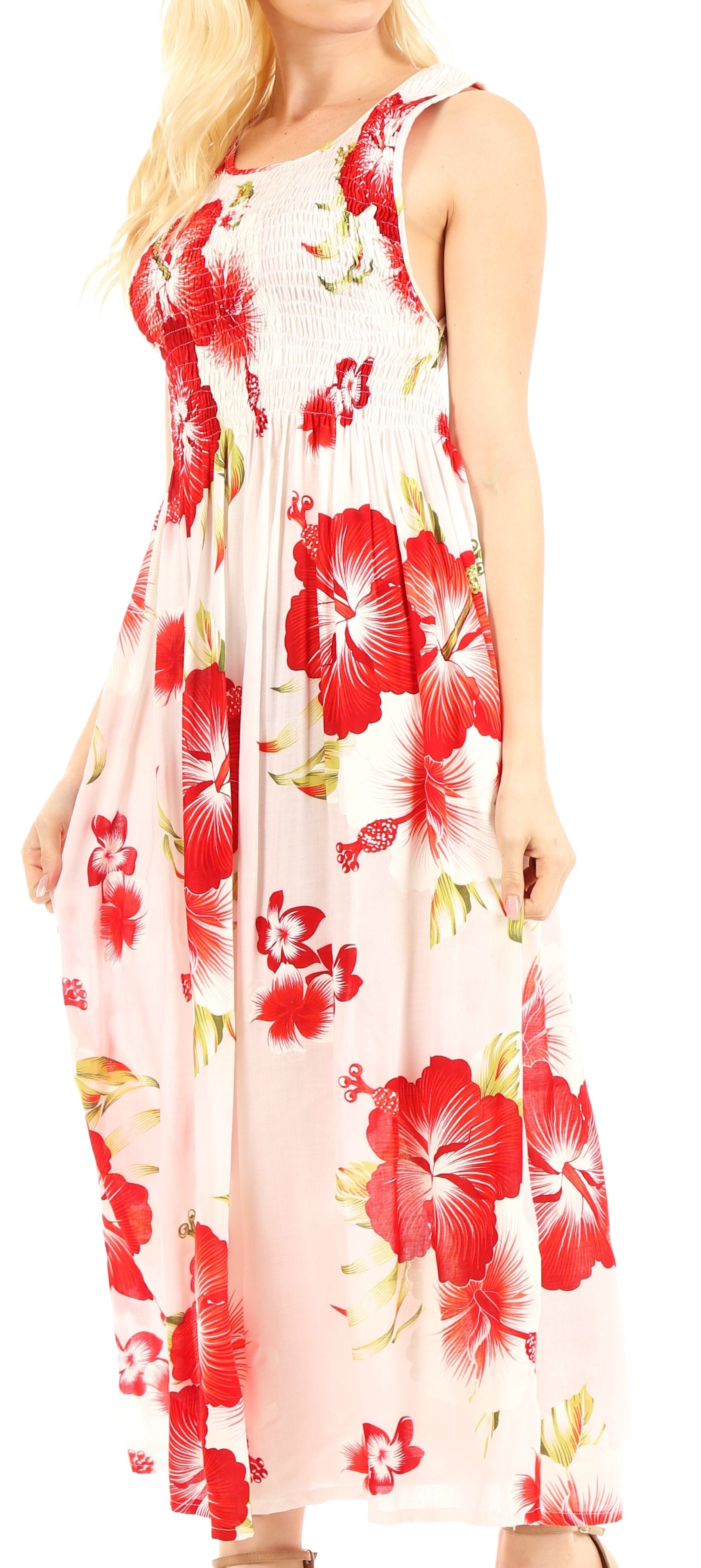 Woman wearing a sleeveless floral dress with red and white flowers on a light background