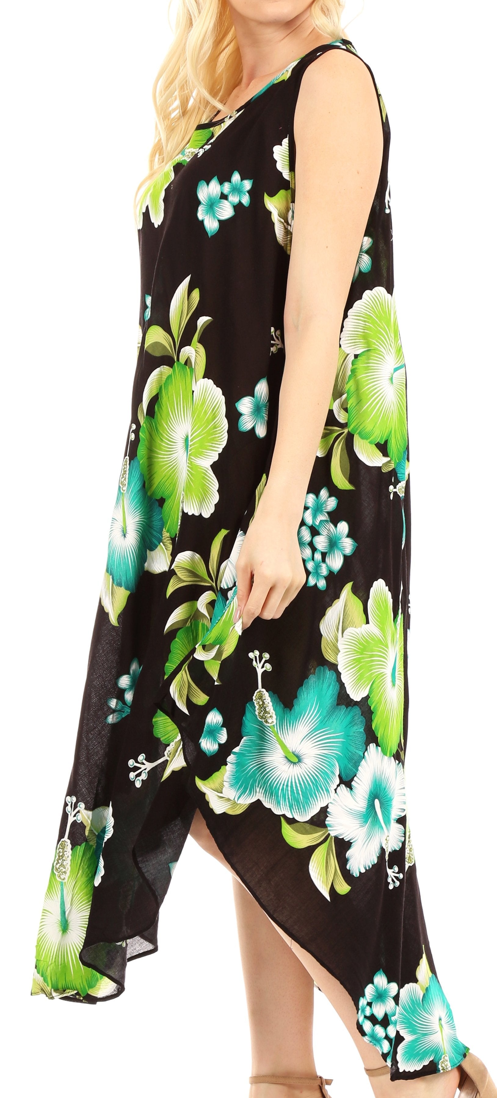 Woman wearing a black sleeveless dress with green floral patterns.