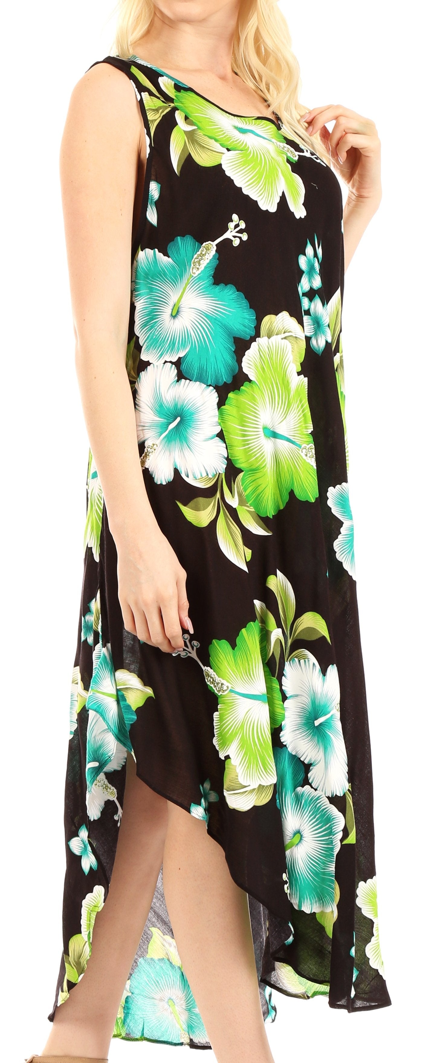 Woman wearing a sleeveless dress with green floral pattern on a black background