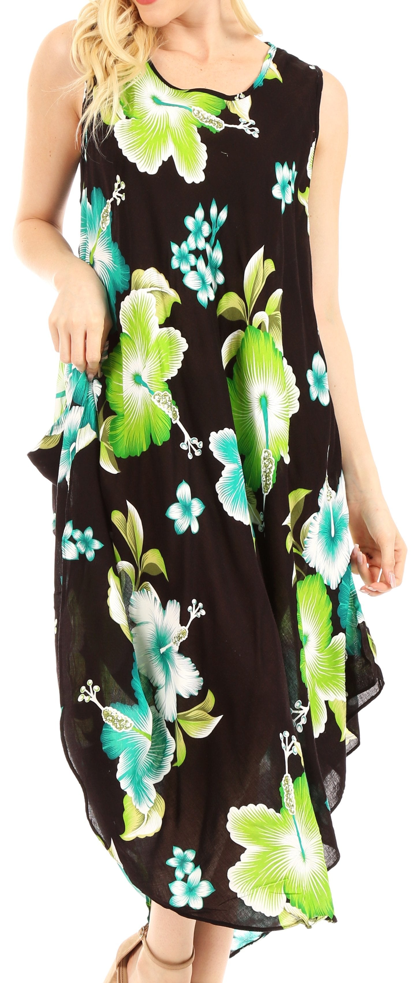 Woman wearing a black sleeveless dress with green and blue floral patterns.