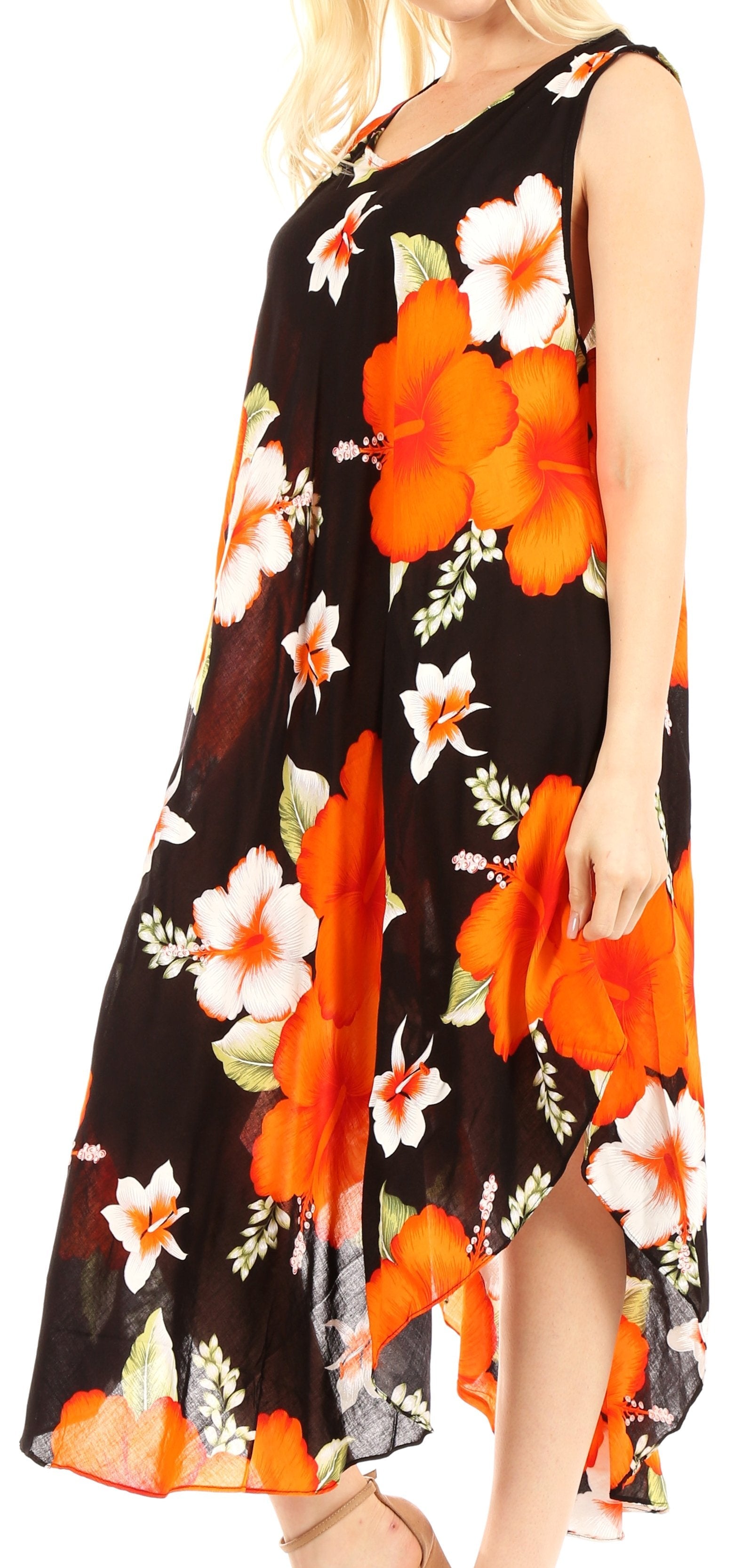 Woman wearing a black floral dress with orange and white flowers on a plain background
