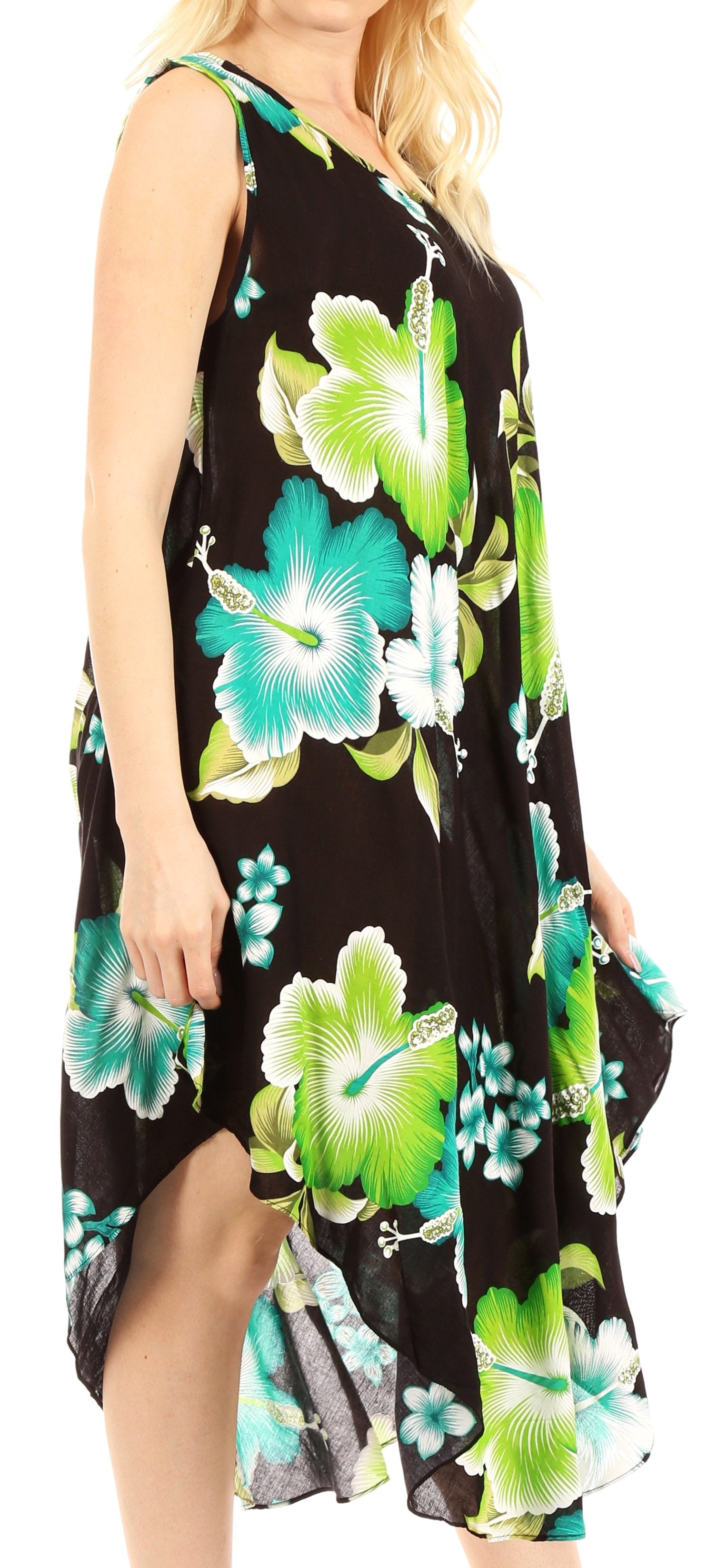 Woman wearing a black sleeveless dress with green and blue floral pattern