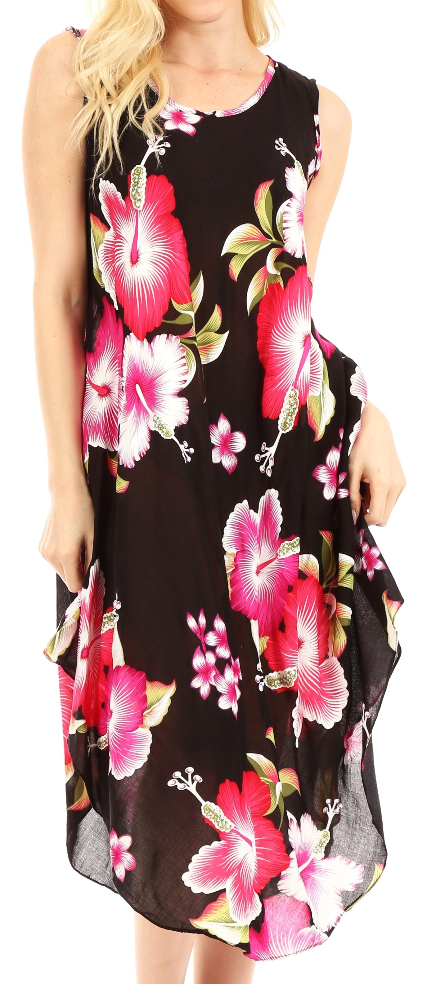 Woman wearing a sleeveless dress with pink floral pattern on a black background