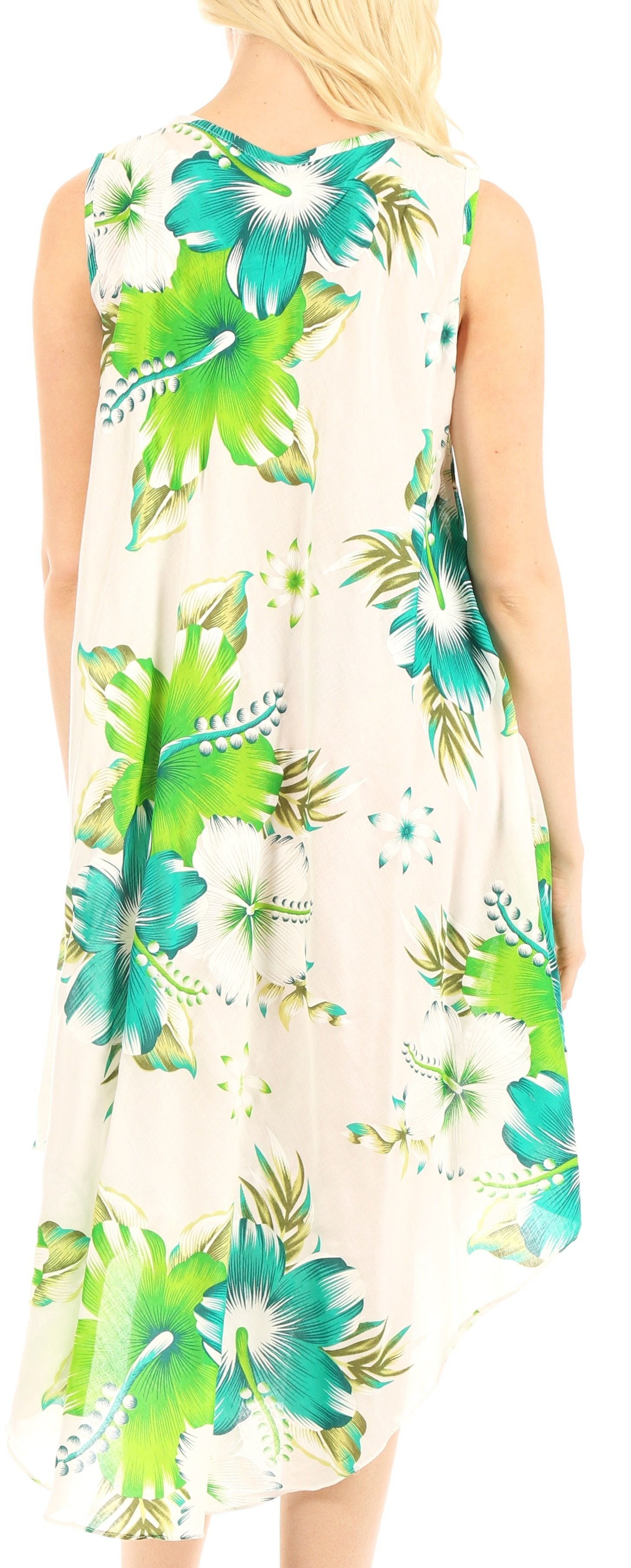 Beige sleeveless dress with green floral pattern worn by a person