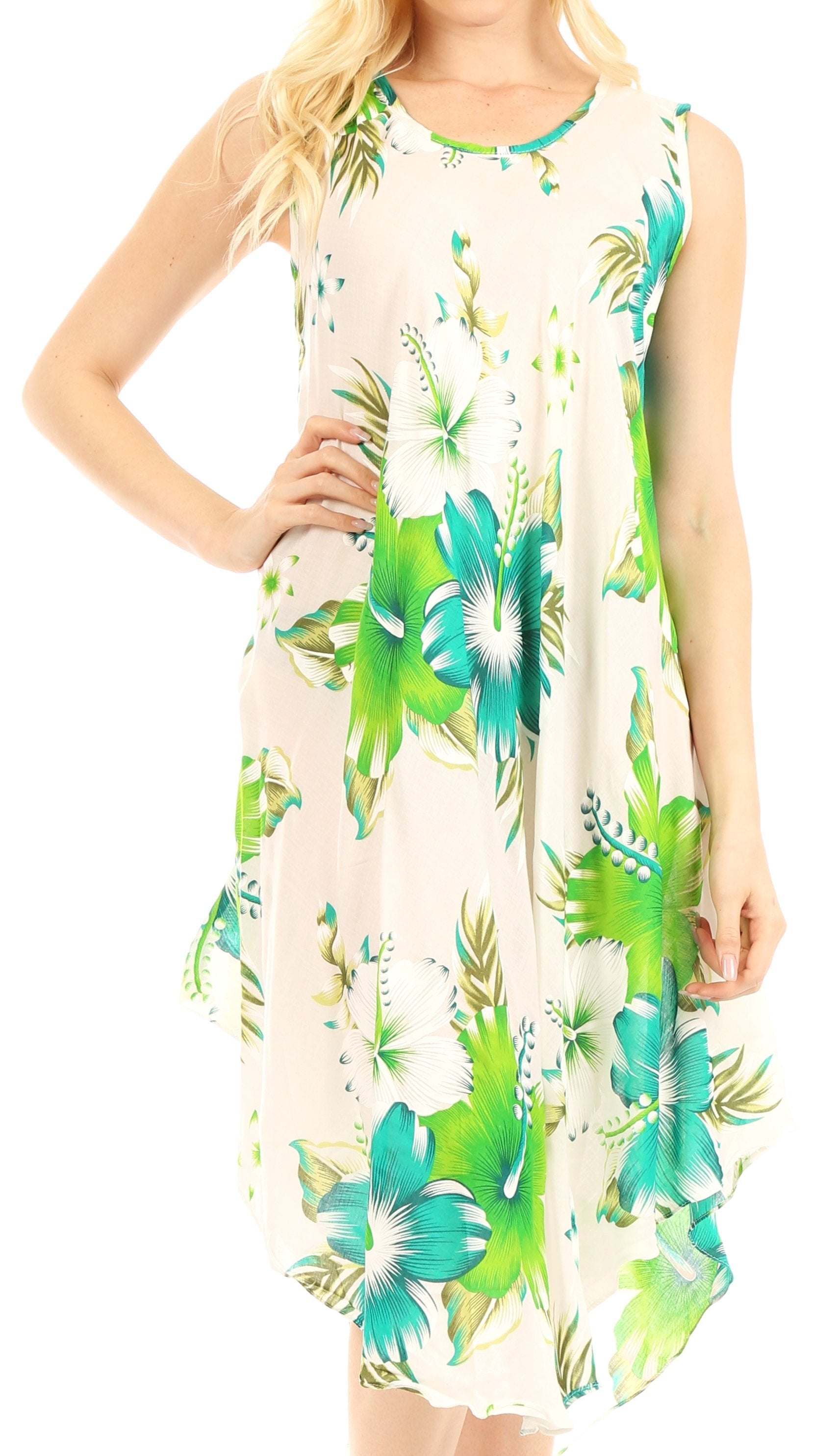 Woman wearing a sleeveless dress with green floral pattern on a white background