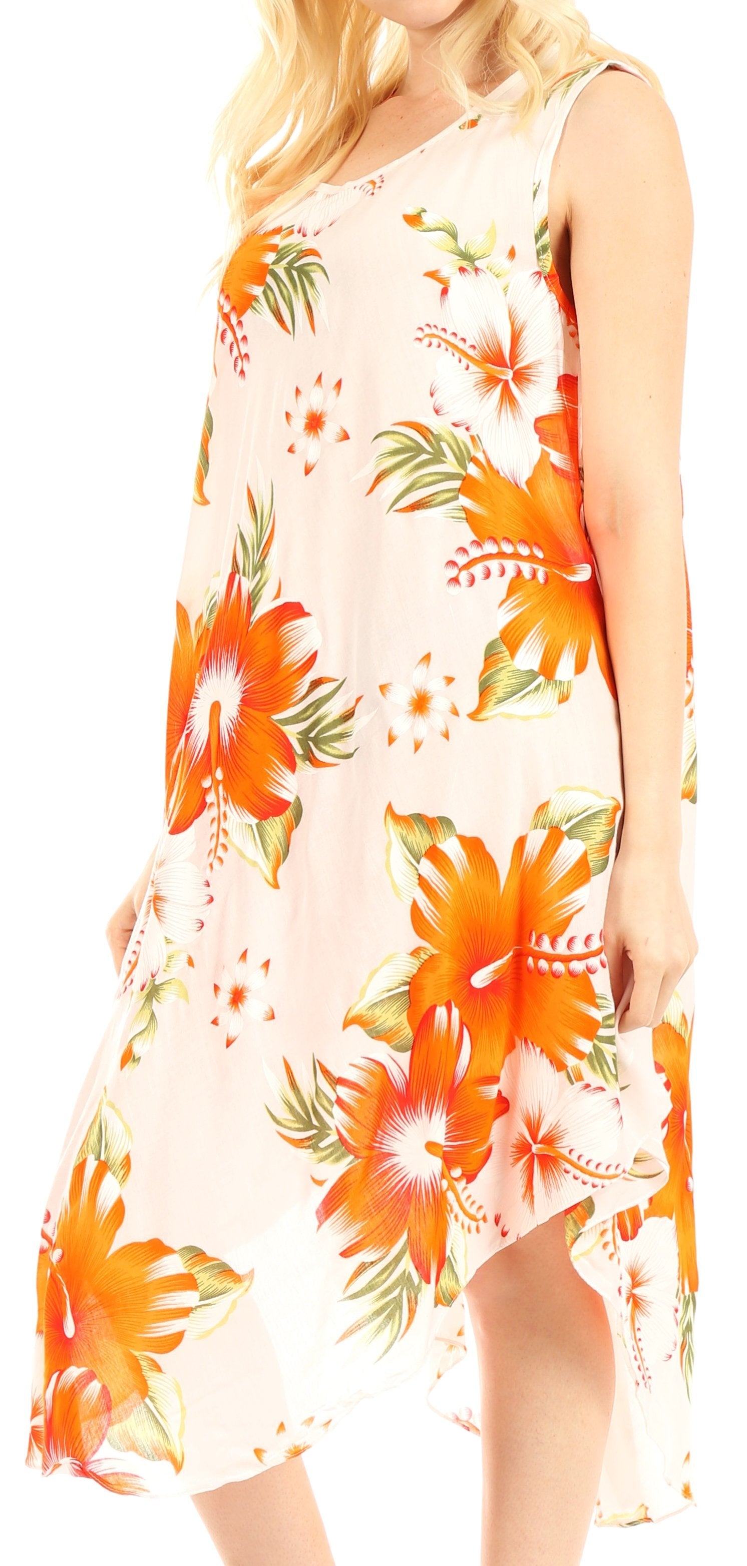Woman wearing a sleeveless dress with orange floral pattern on a light background