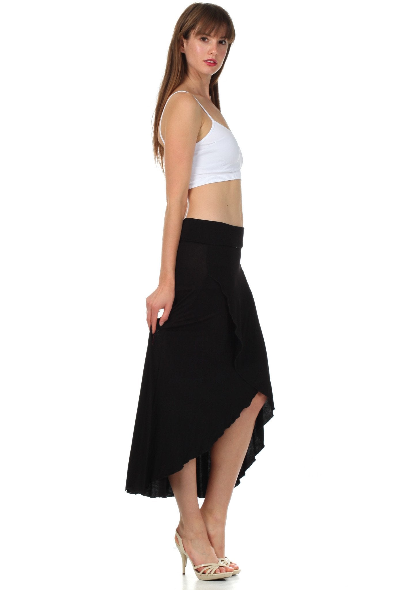 Woman wearing a white top and black skirt on a white background