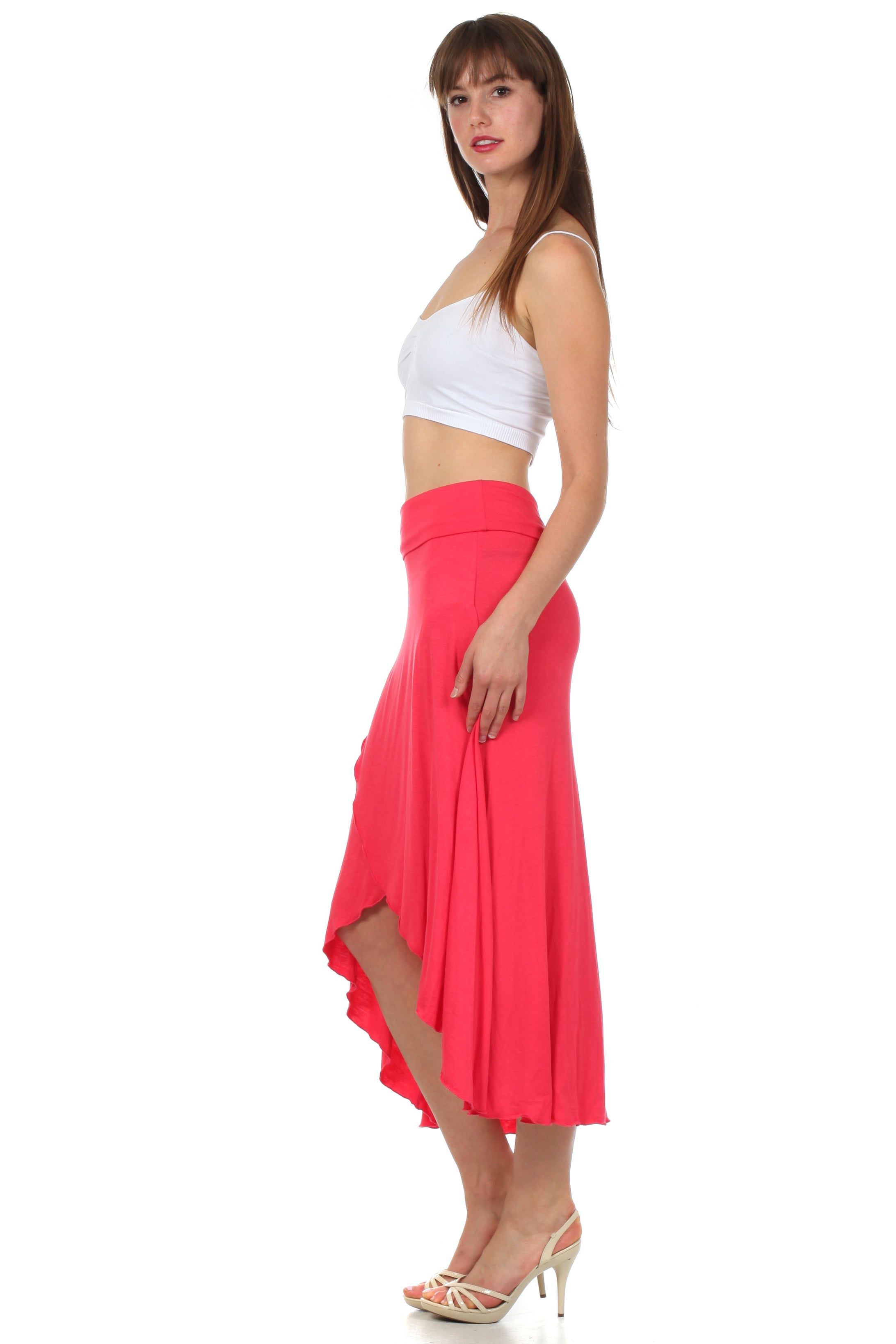 Woman wearing a white top and pink skirt on a white background