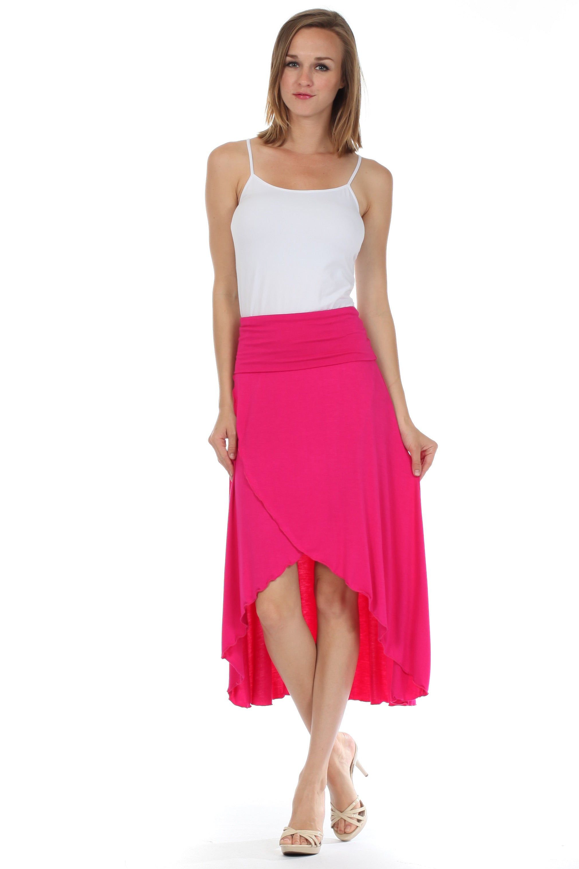 Woman wearing a white top and bright pink skirt on a white background