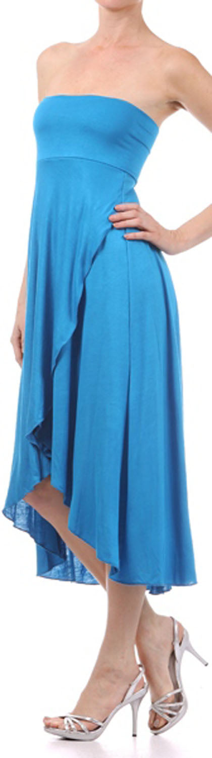 Woman wearing a blue strapless dress with an asymmetrical hem on a white background