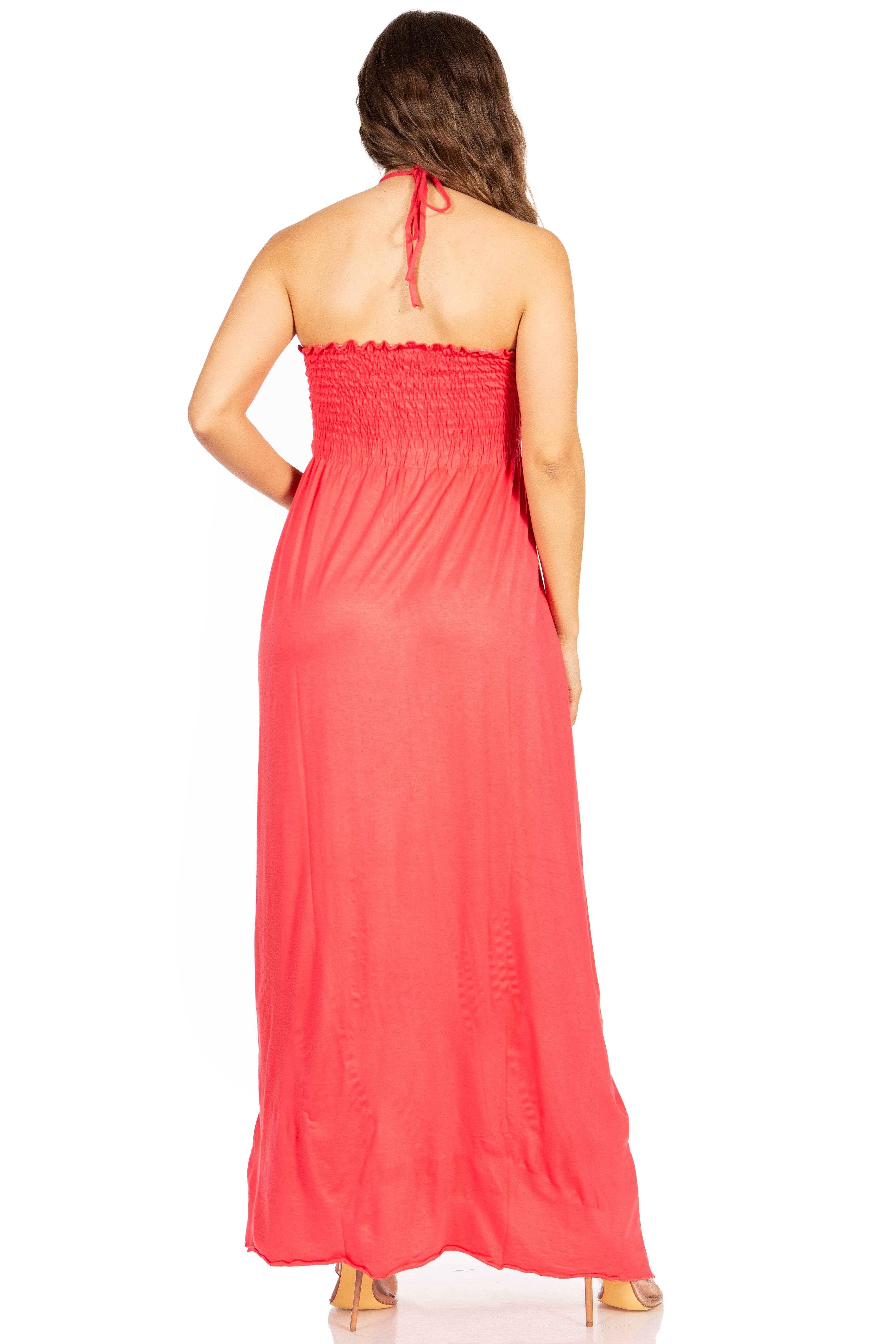 Woman wearing a coral halter neck dress on a white background