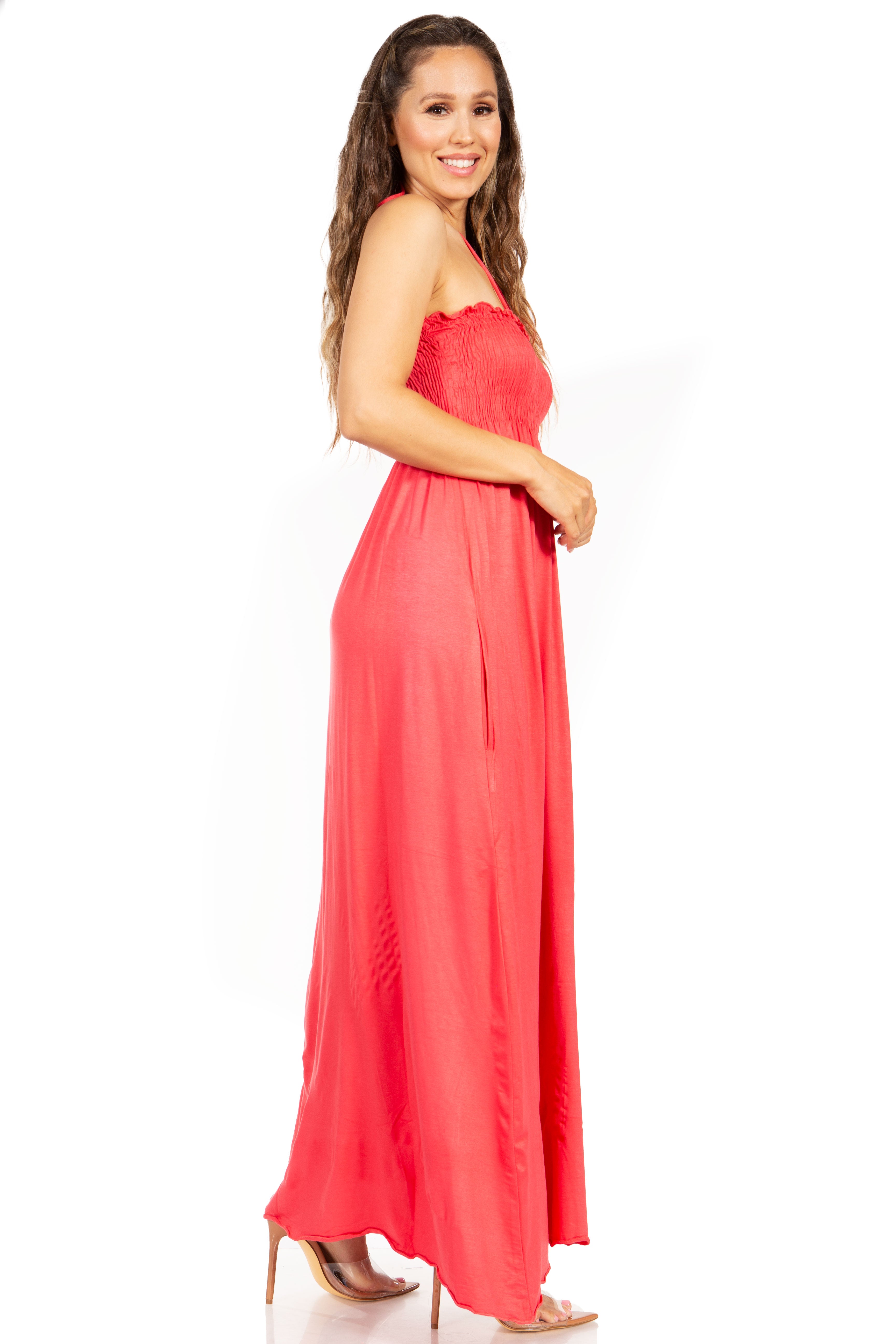 Woman wearing a coral strapless dress on a white background