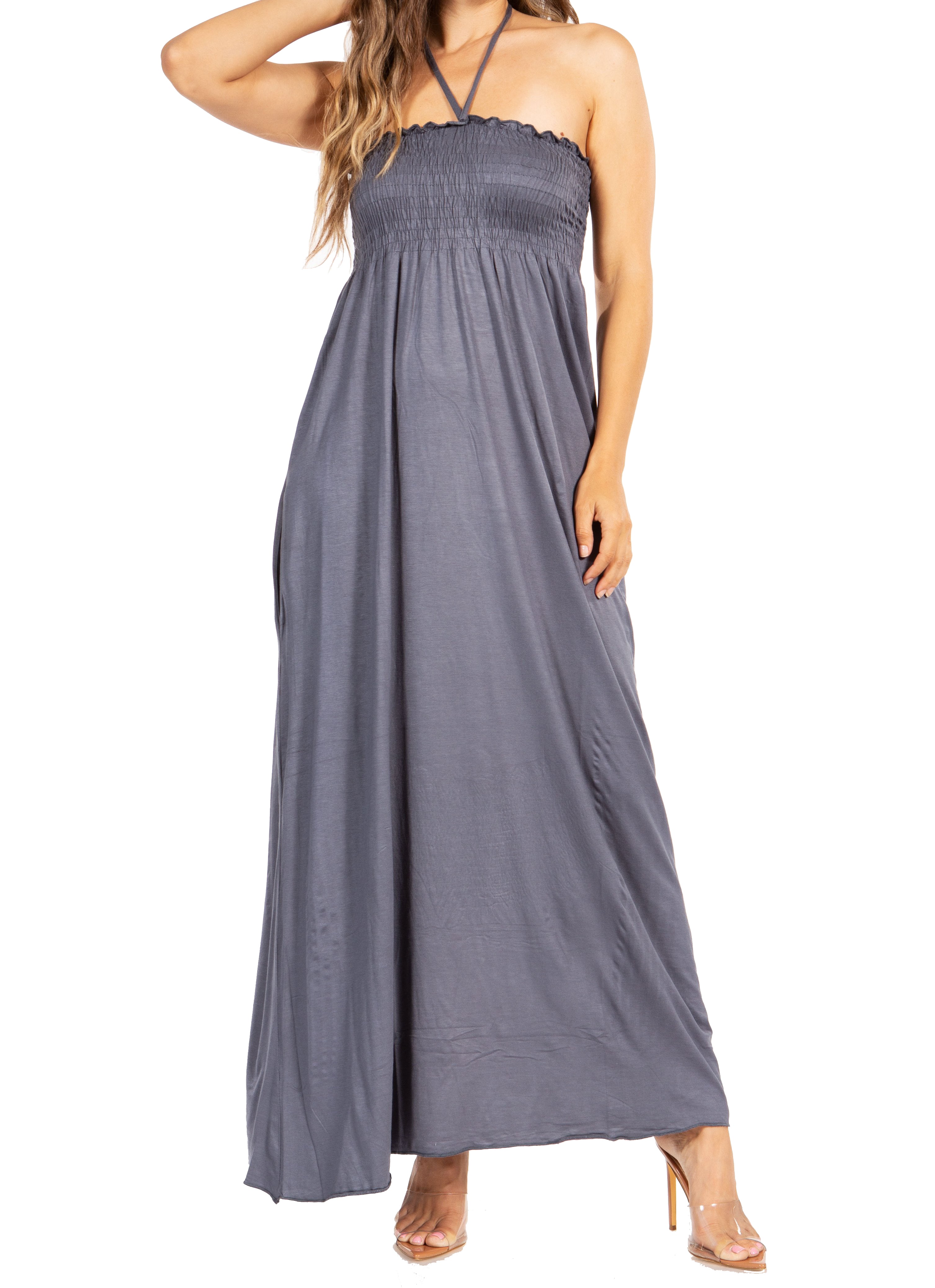 Woman wearing a gray halter neck maxi dress on a white background