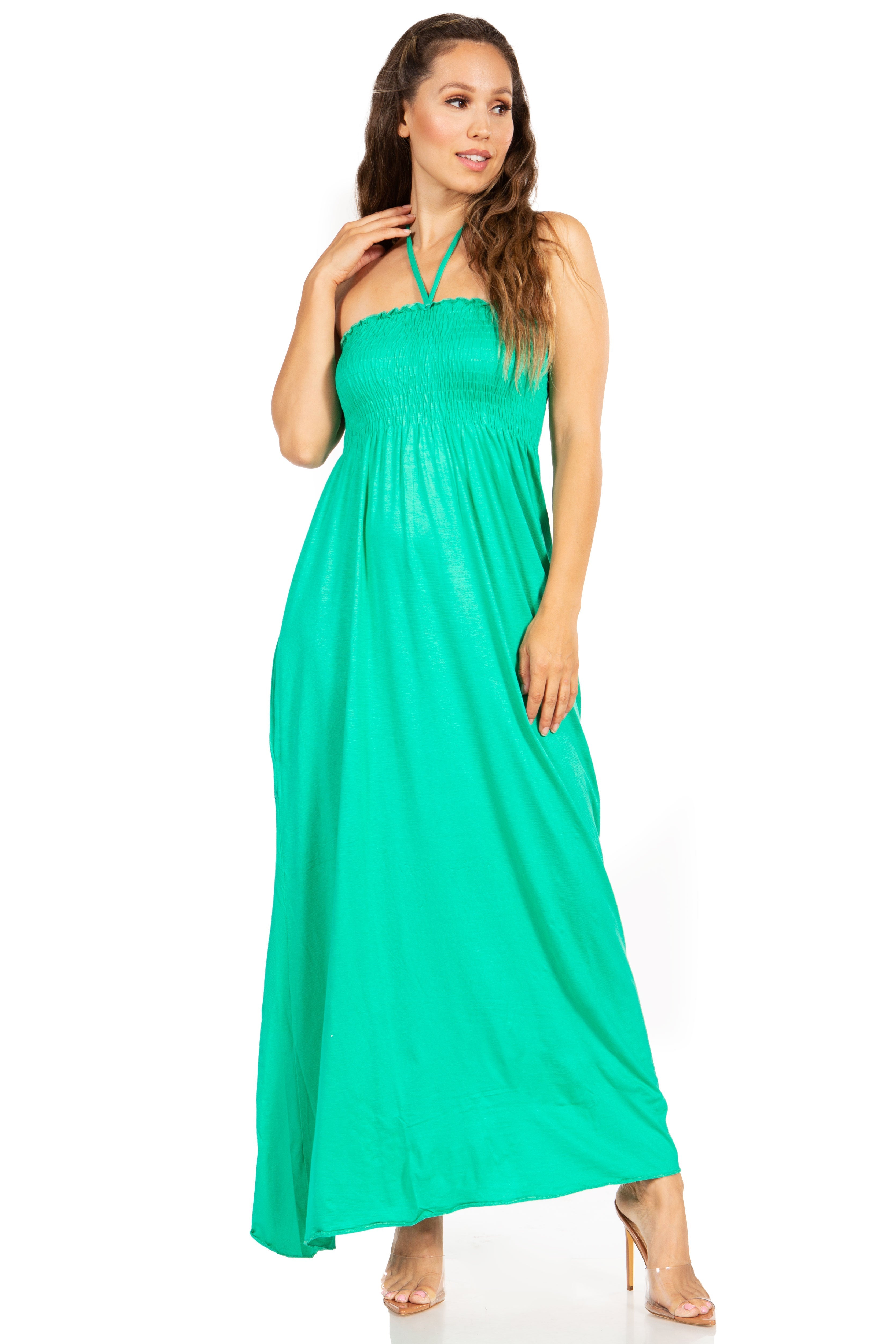 Woman wearing a green halter neck maxi dress on a white background