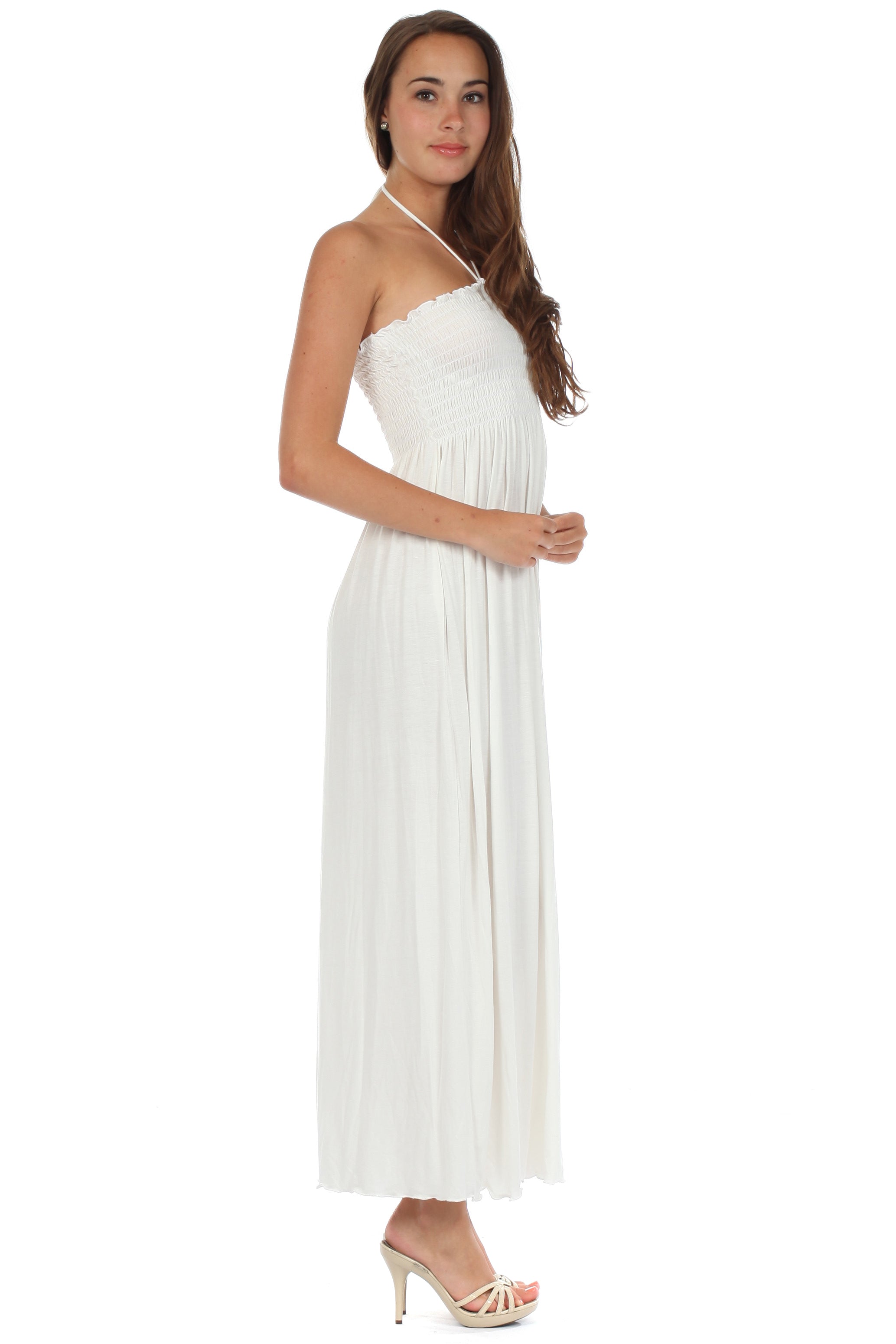 Woman wearing a white halter neck dress on a white background