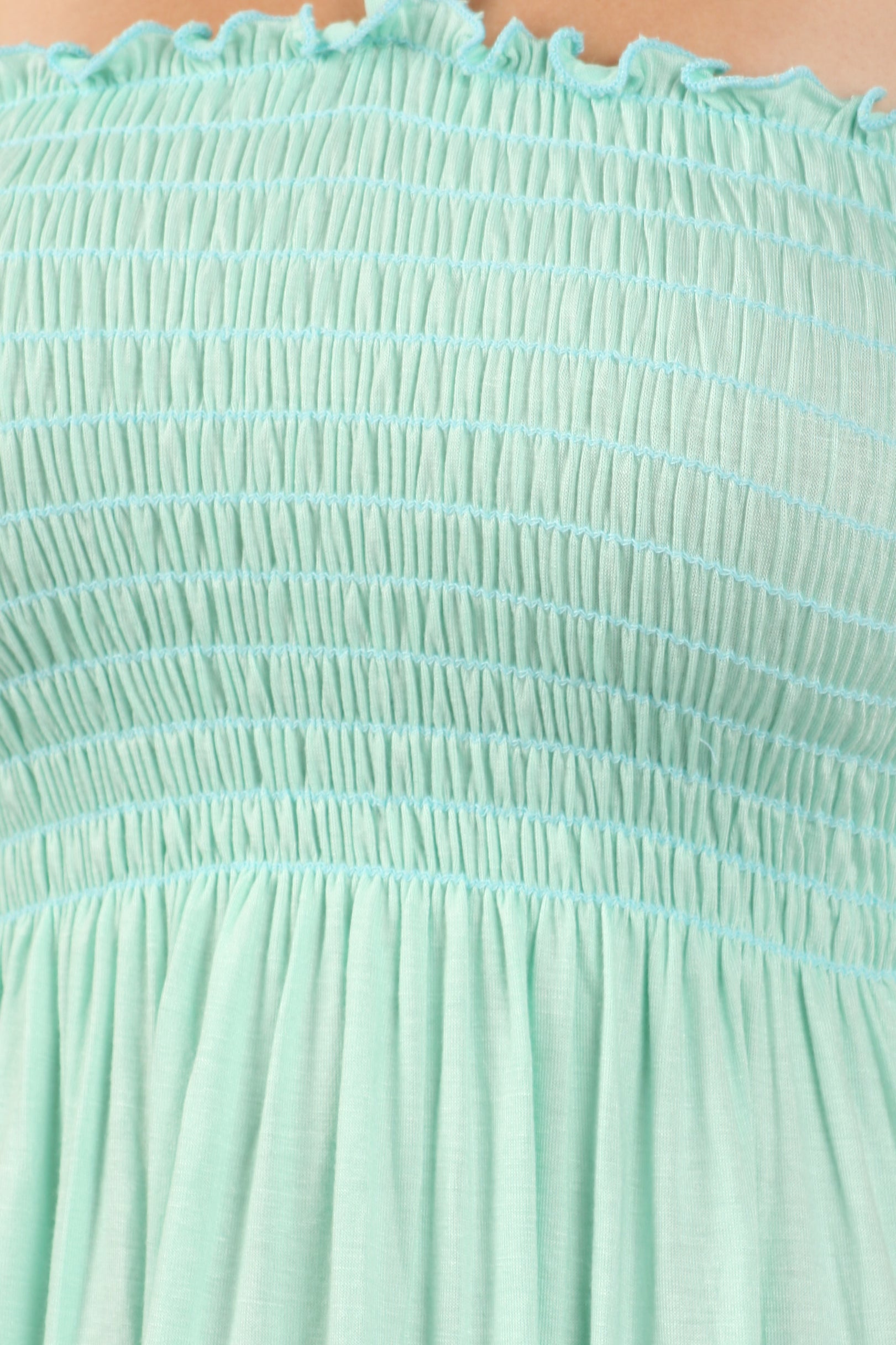 Close-up of a mint green dress with textured fabric