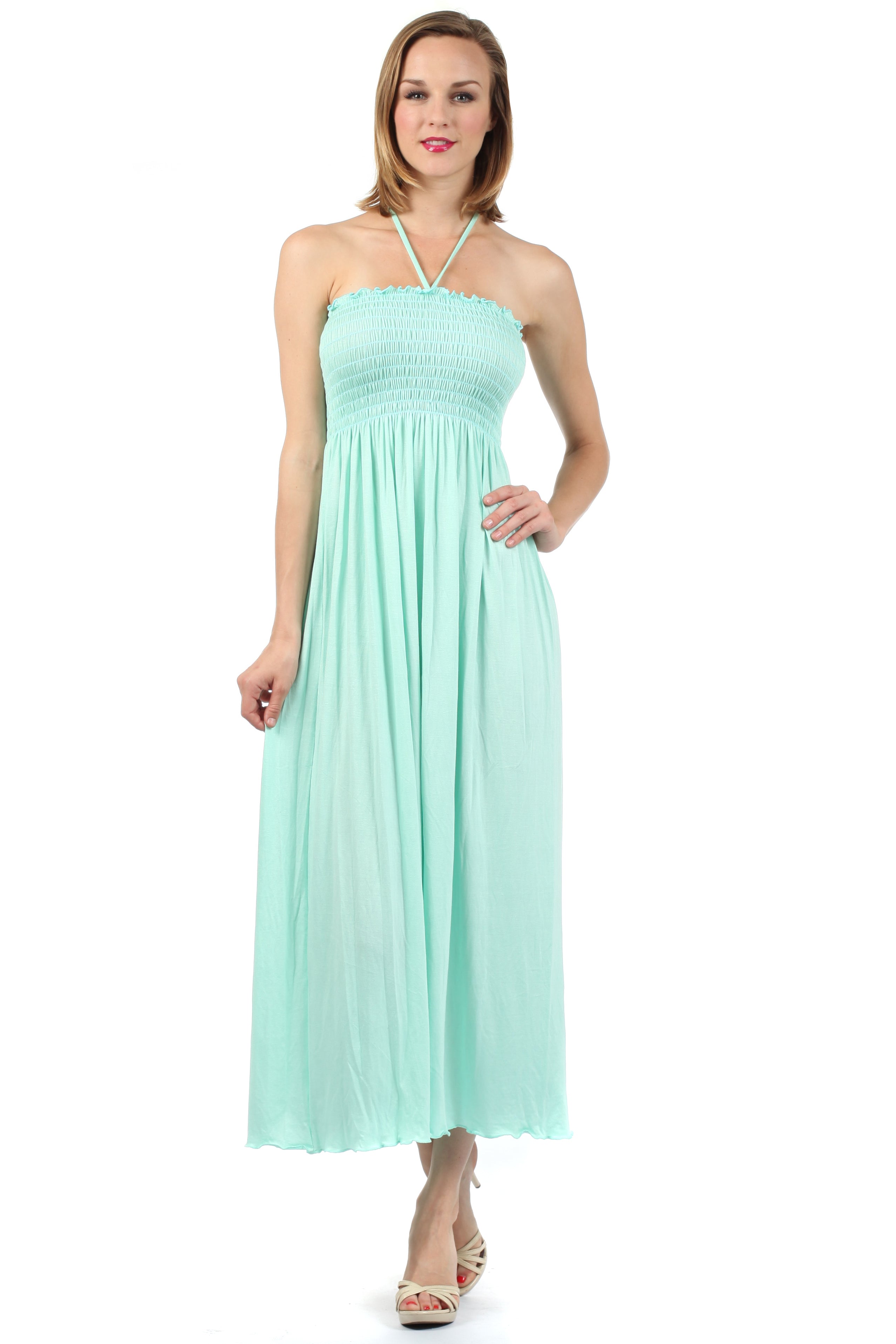 Woman wearing a light blue halter neck dress on a white background