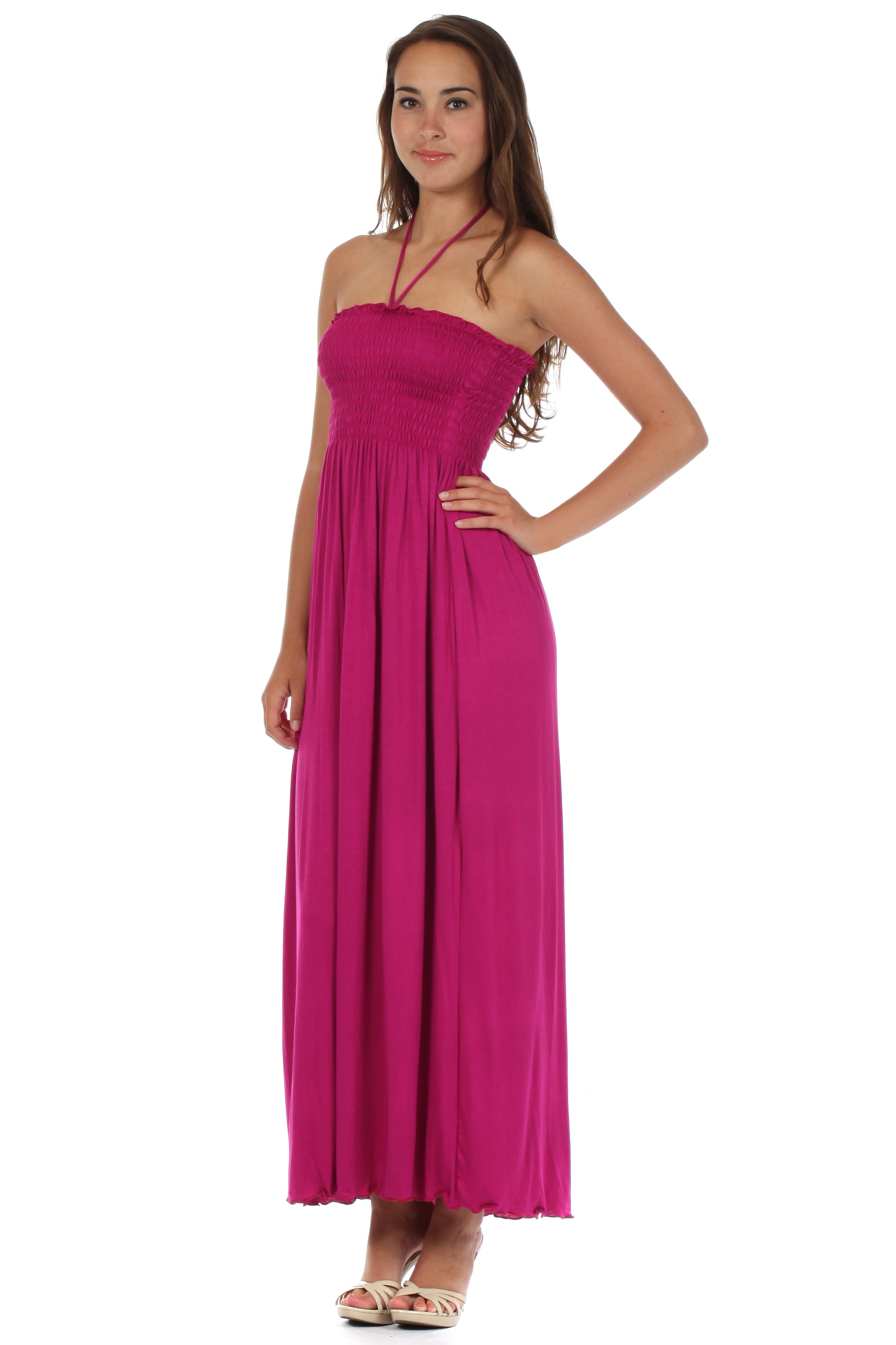 Woman wearing a pink halter neck dress on a white background