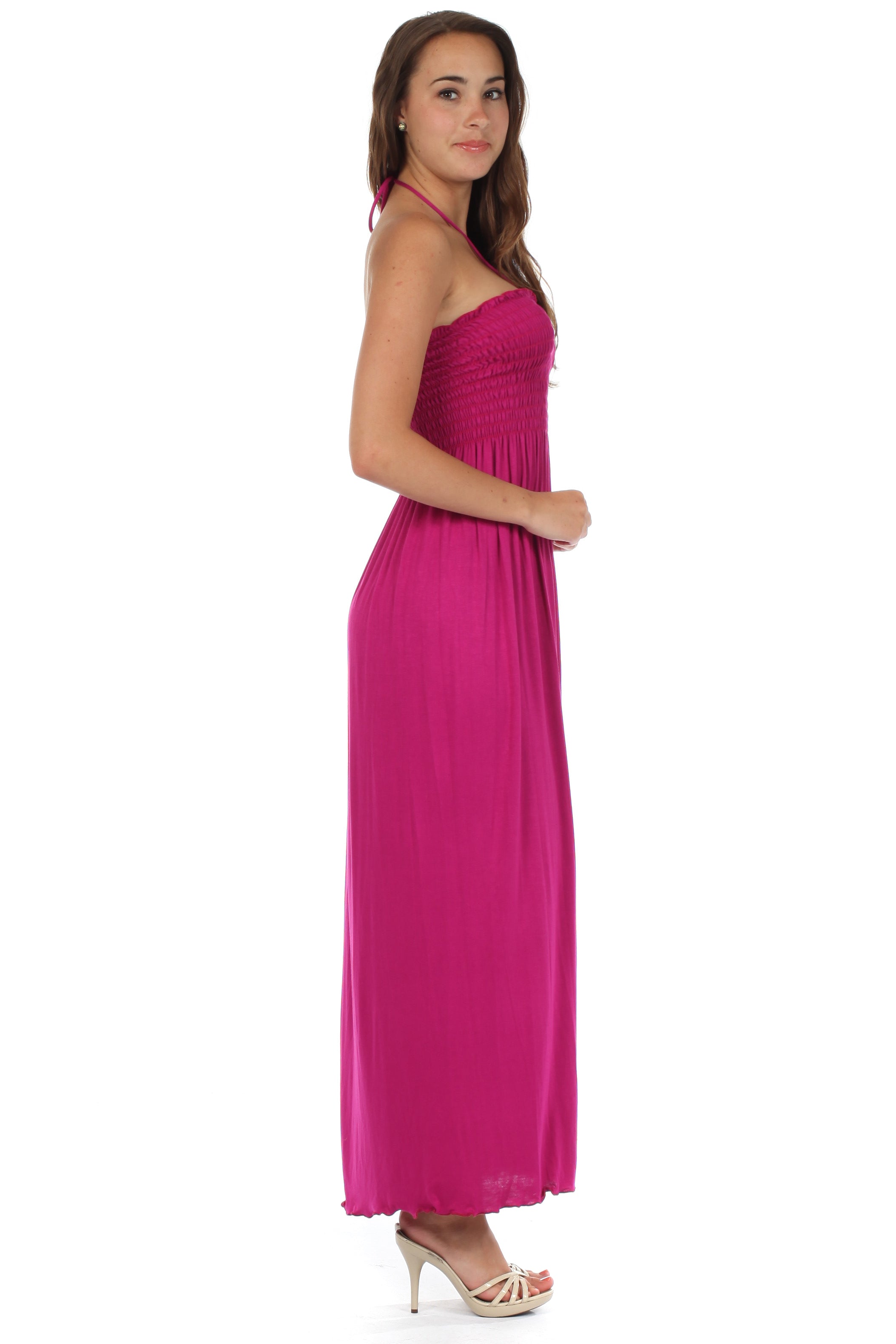 Woman wearing a pink halter neck dress on a white background