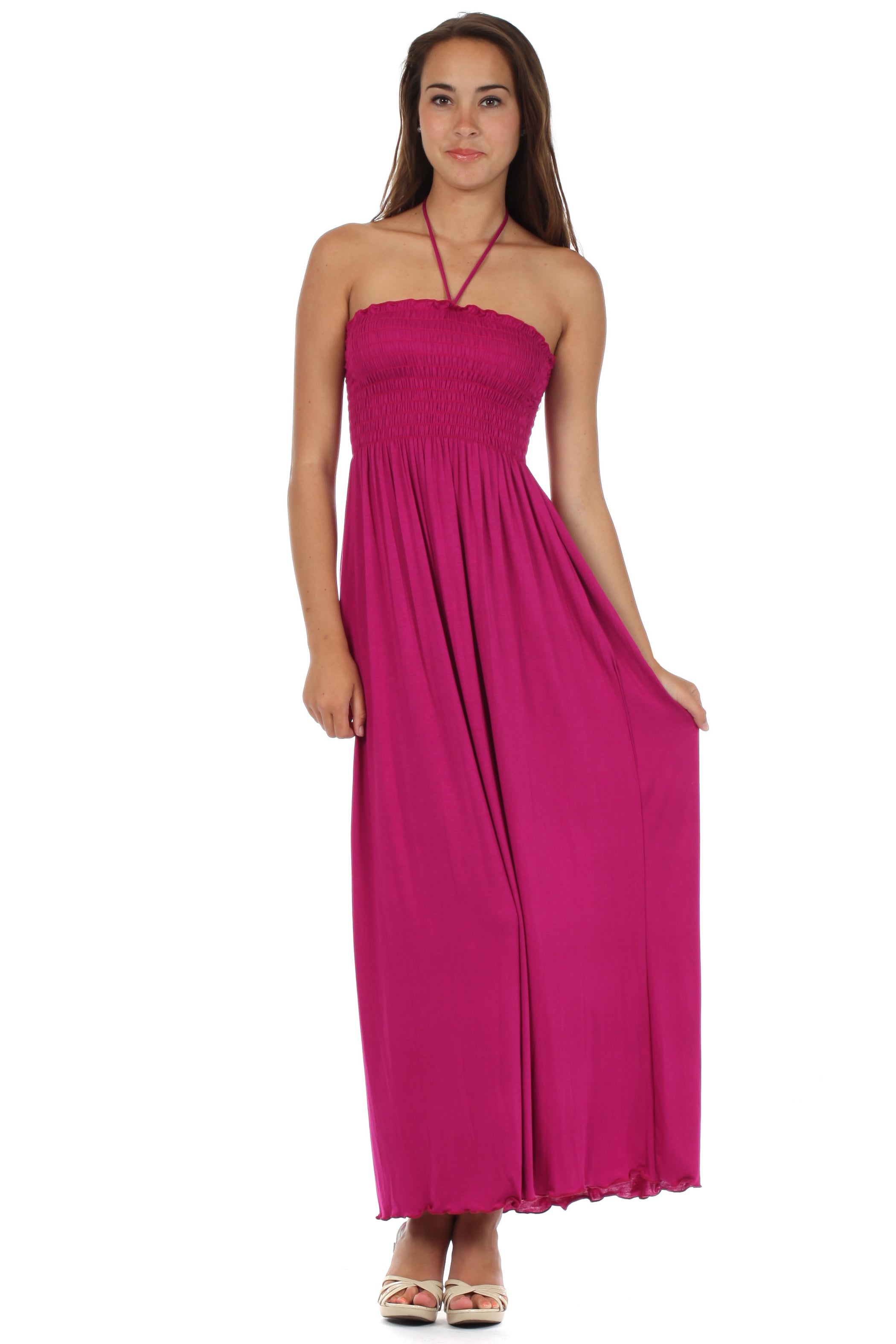 Woman wearing a pink halter neck dress on a white background