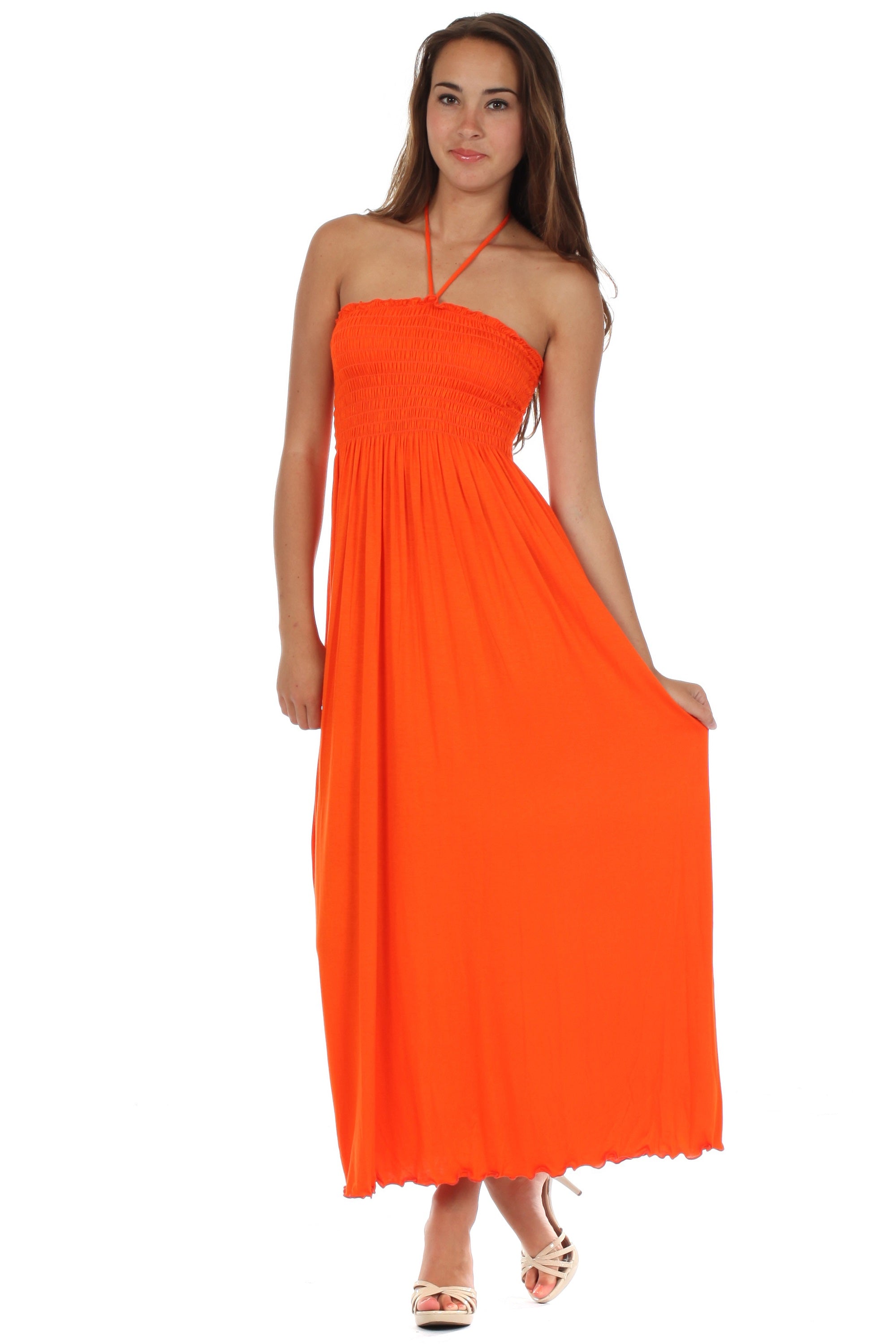 Woman wearing an orange halter neck dress on a white background