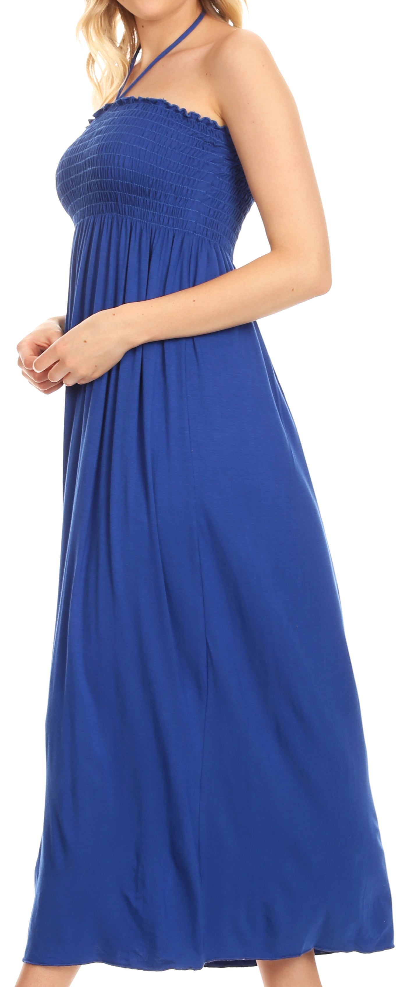 Woman wearing a blue halter neck dress on a white background