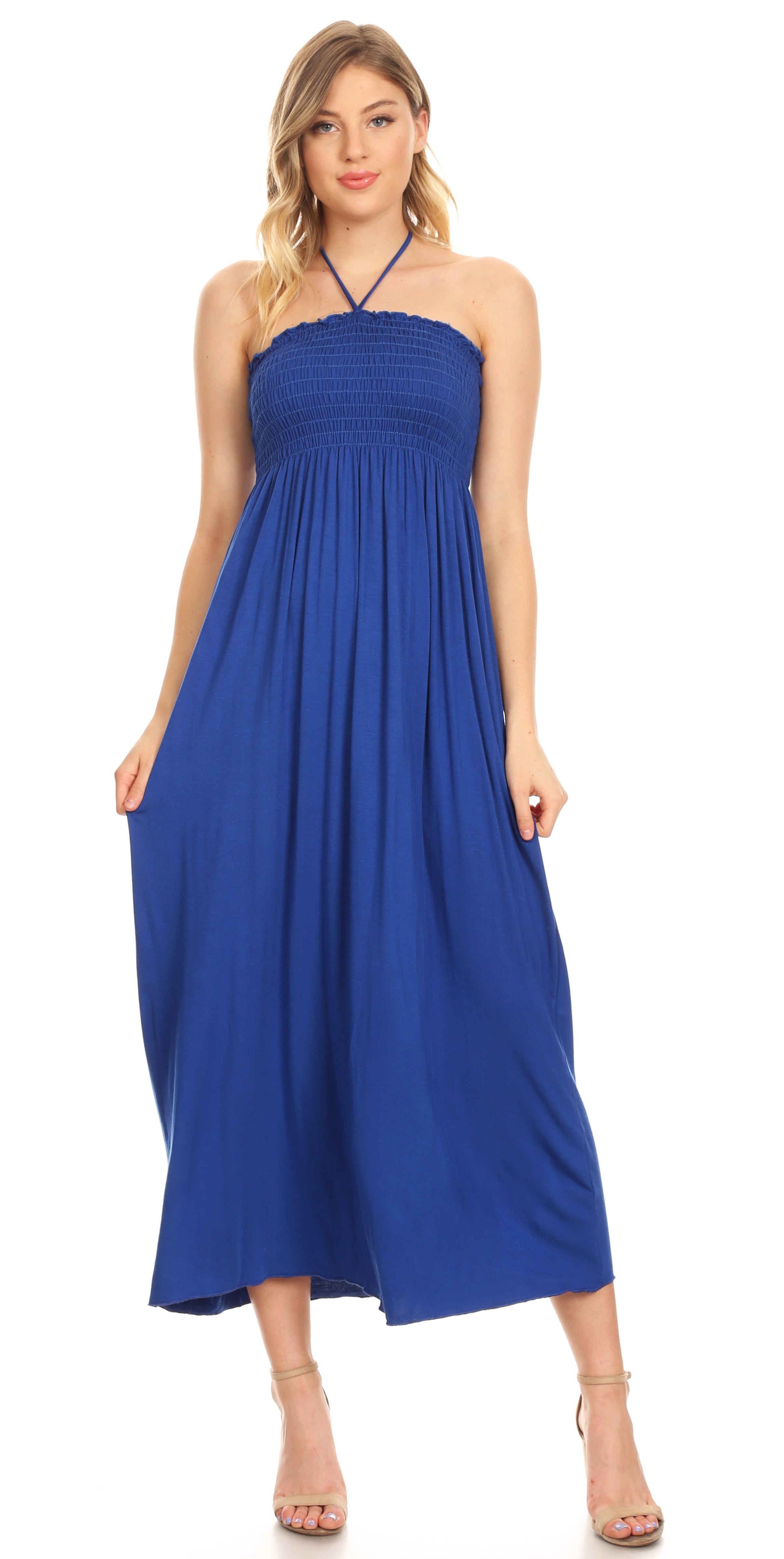 Woman wearing a blue halter neck dress on a white background