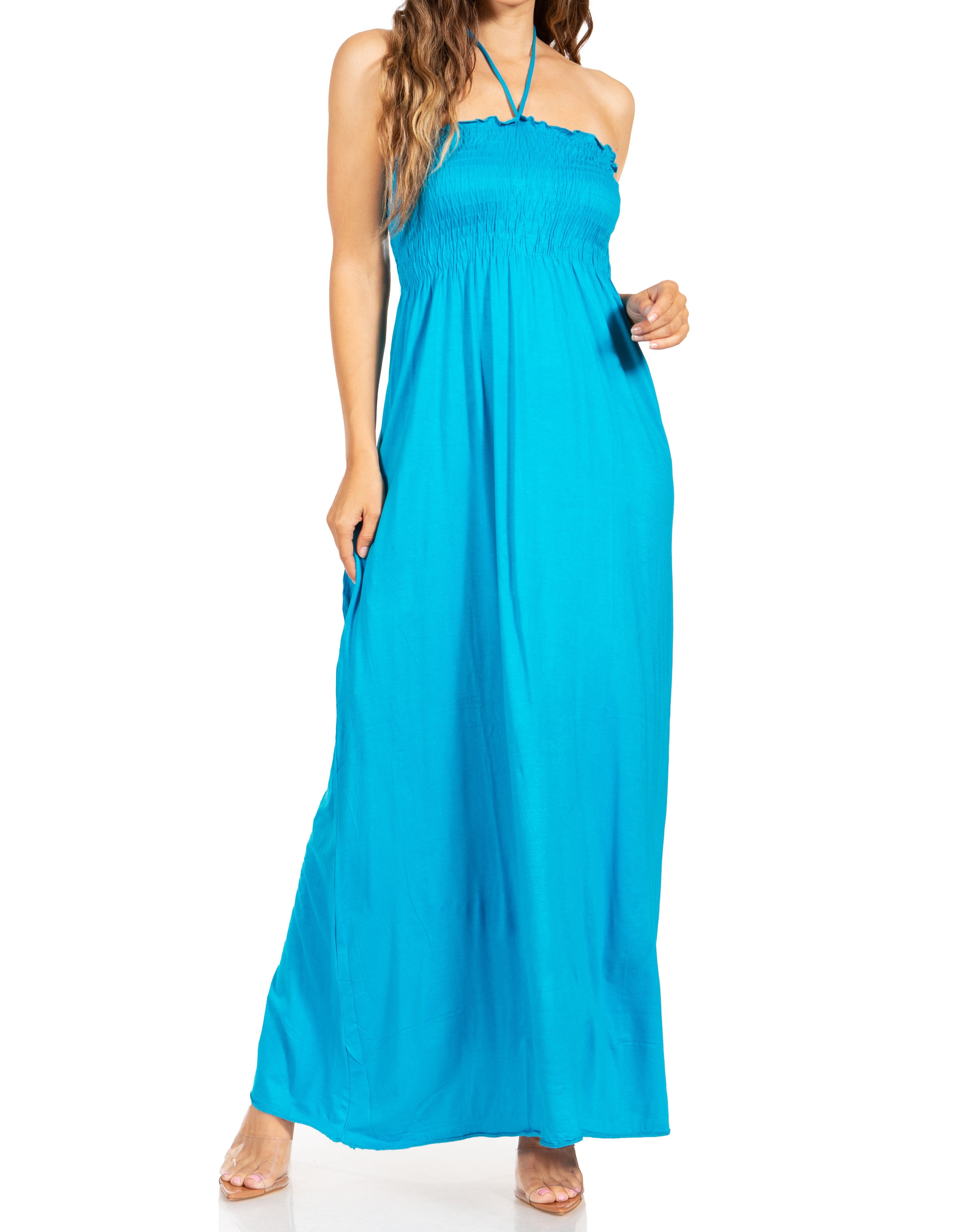 Woman wearing a blue halter neck maxi dress on a white background
