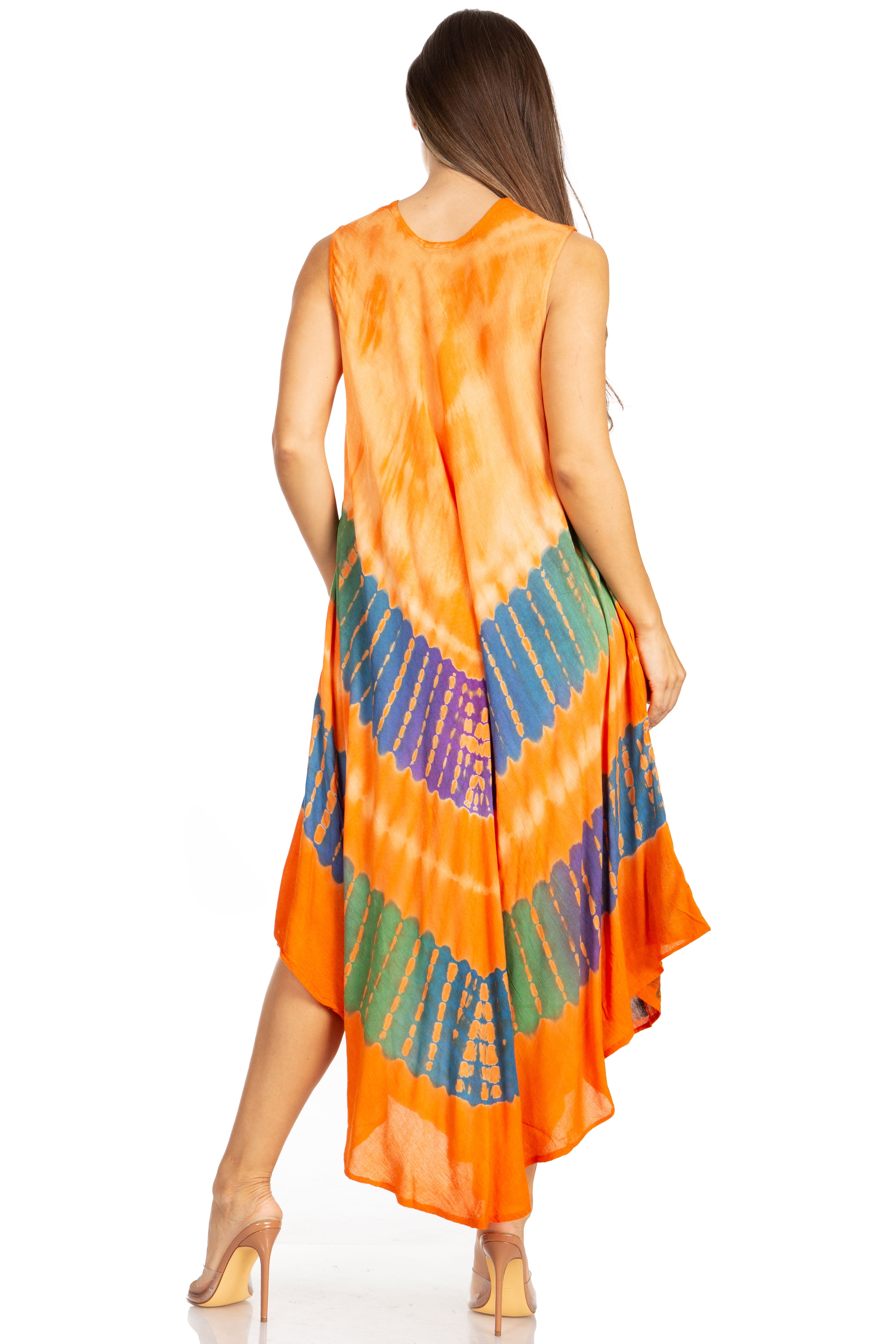 Woman wearing an orange tie-dye dress with a colorful pattern on a white background