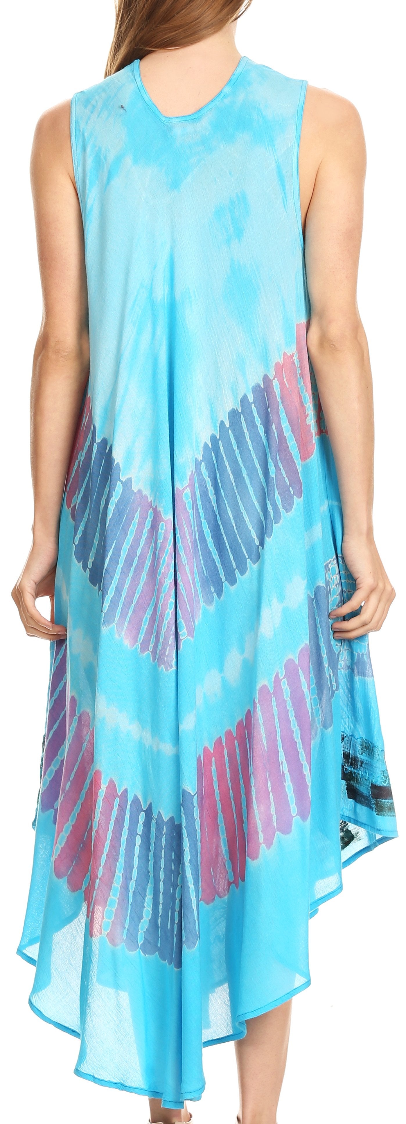 Woman wearing a sleeveless, high-low dress with a colorful pattern on a light blue background