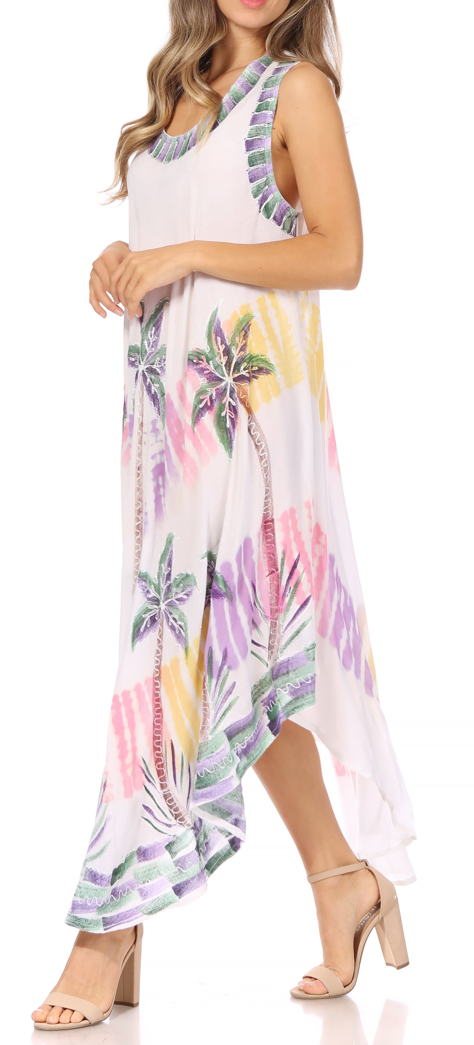Woman wearing a sleeveless dress with colorful floral pattern on a white background