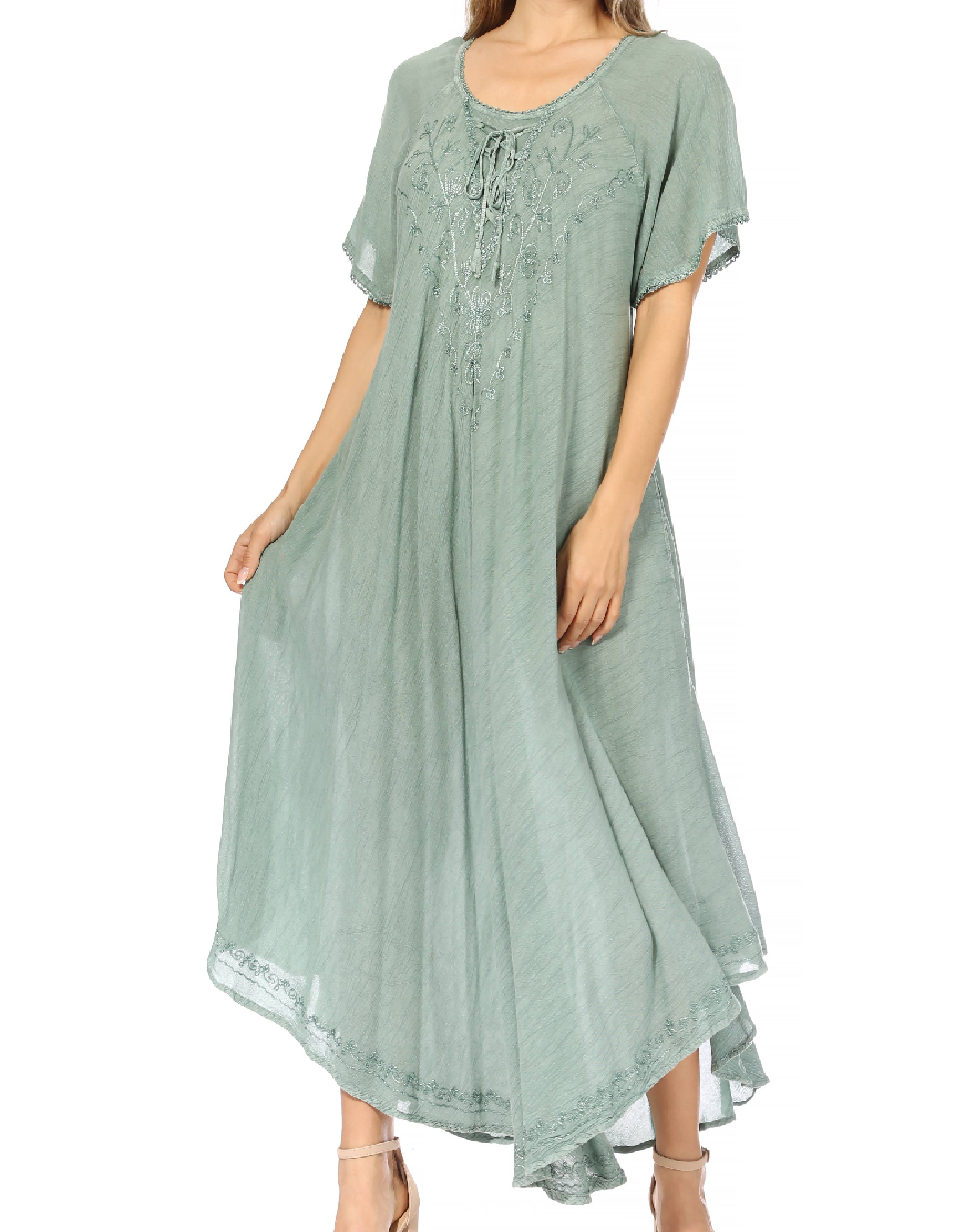 Woman wearing a light green dress with lace details on a white background