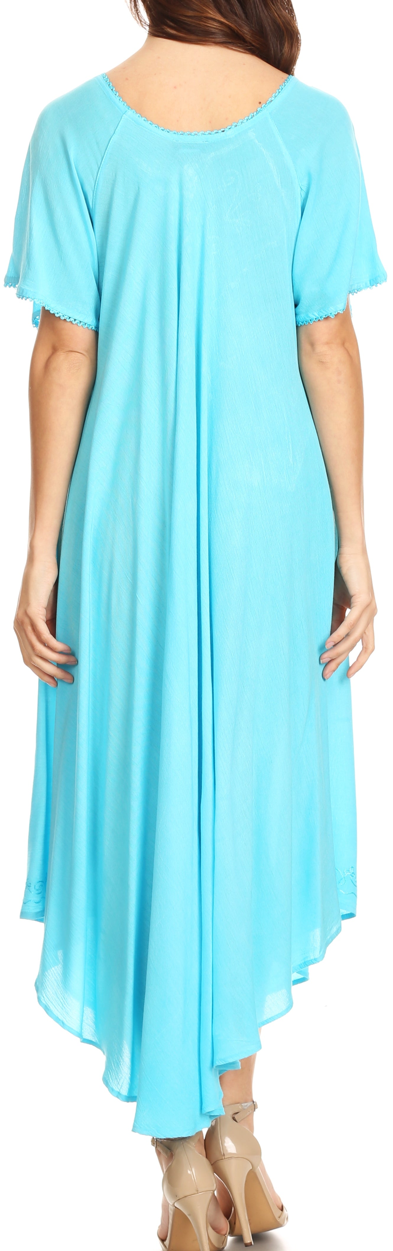 Woman wearing a light blue dress with a plain background
