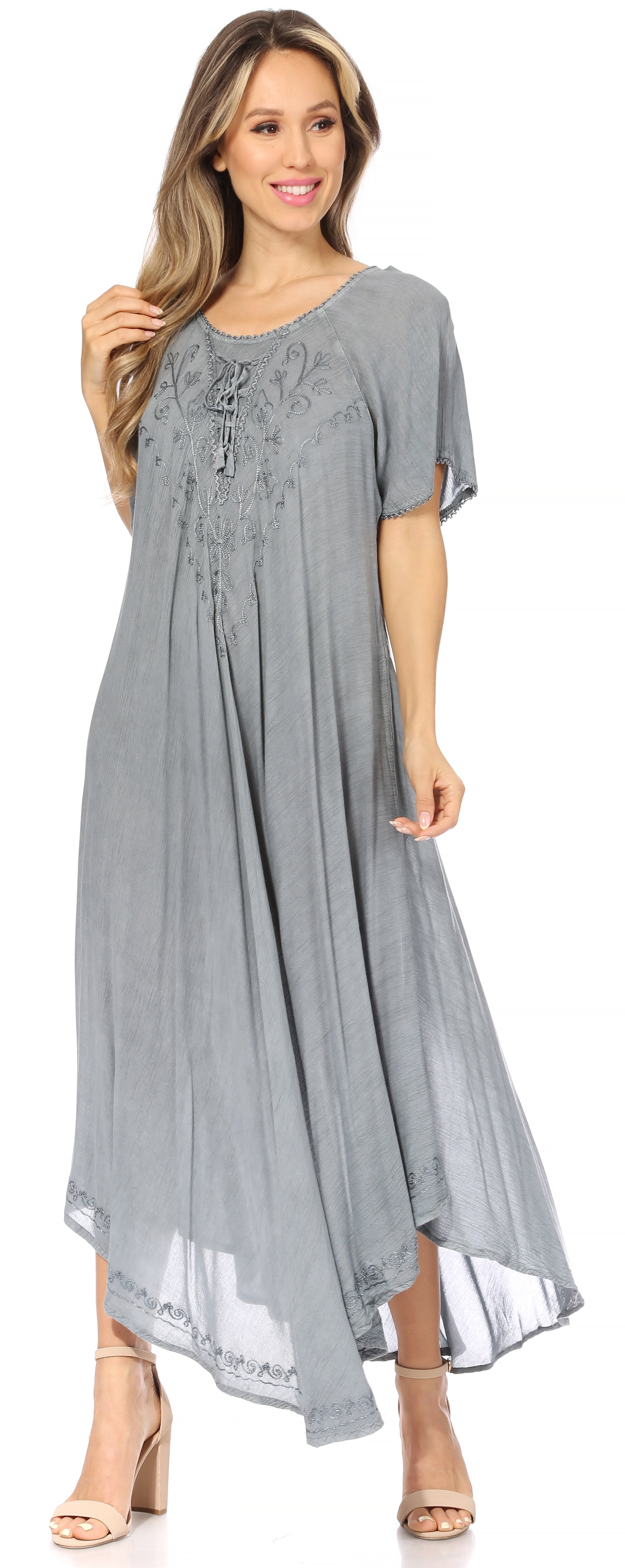 Woman wearing a gray dress with floral embellishments on a white background