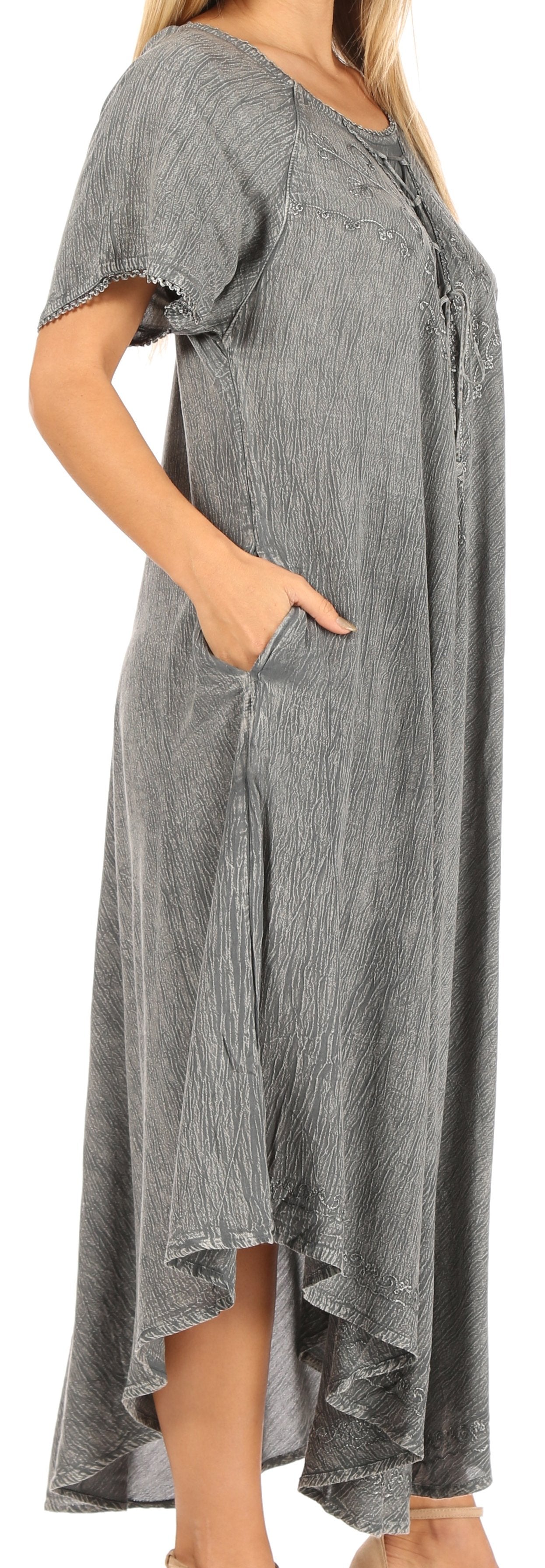 Woman wearing a gray dress with short sleeves and a high-low hemline.