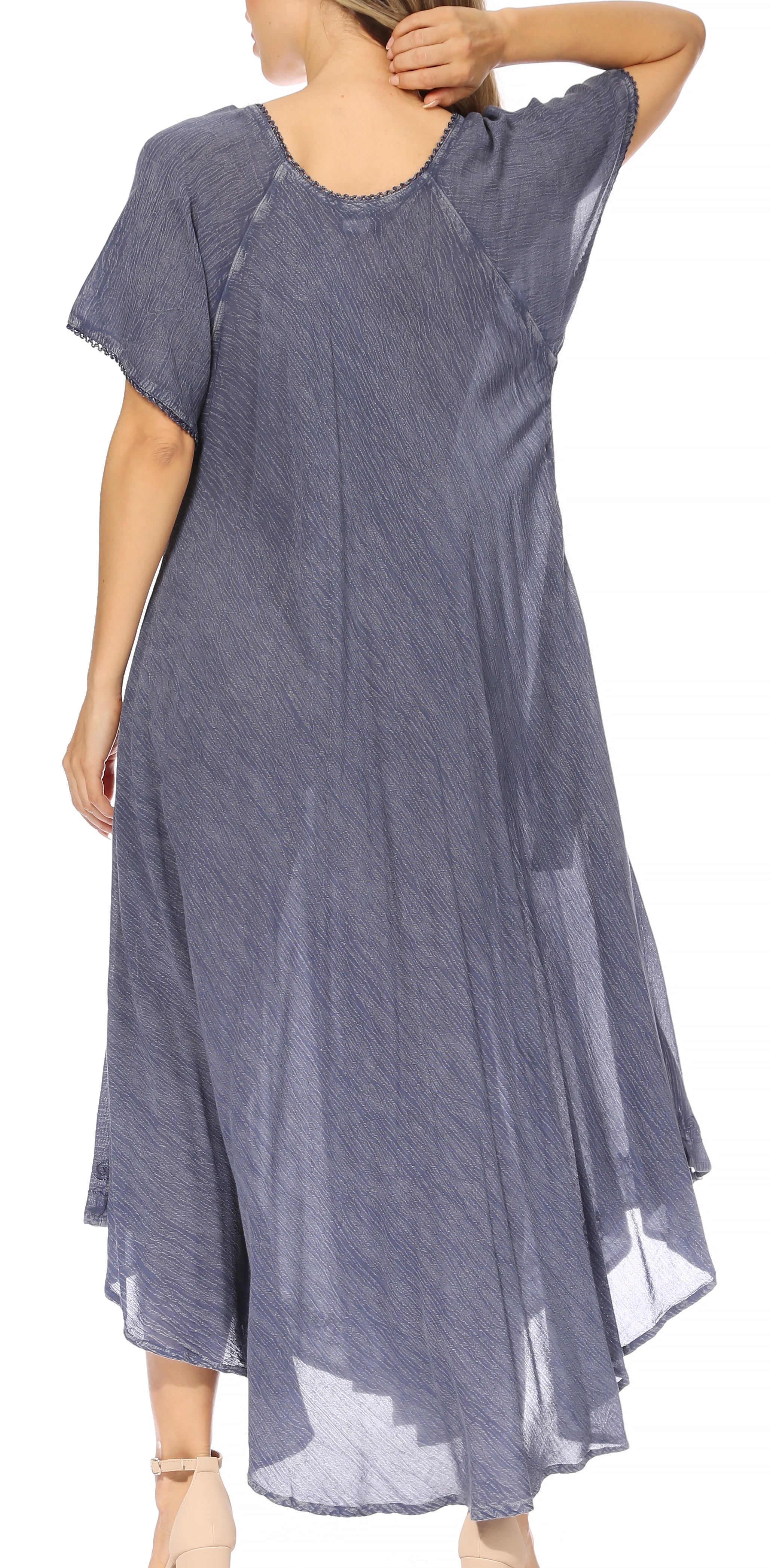 Woman wearing a long, light blue dress with sheer sleeves on a white background