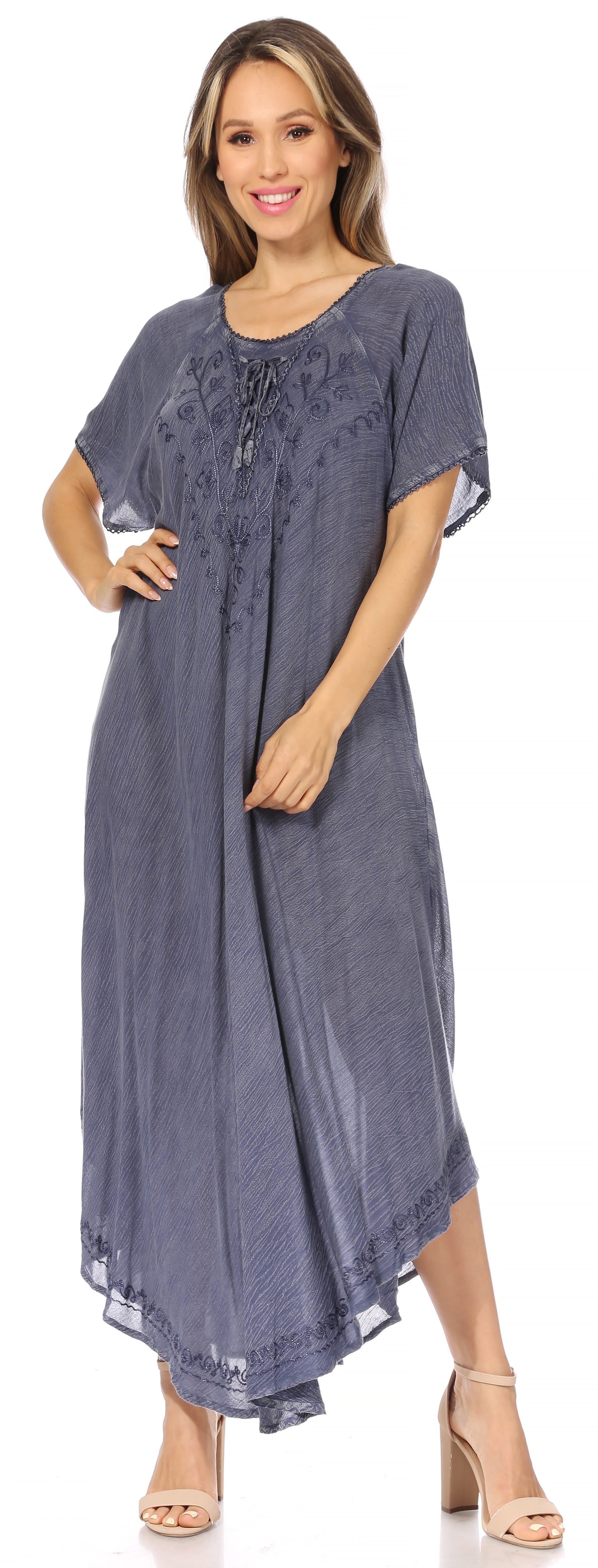 Woman wearing a blue dress with lace details on a white background