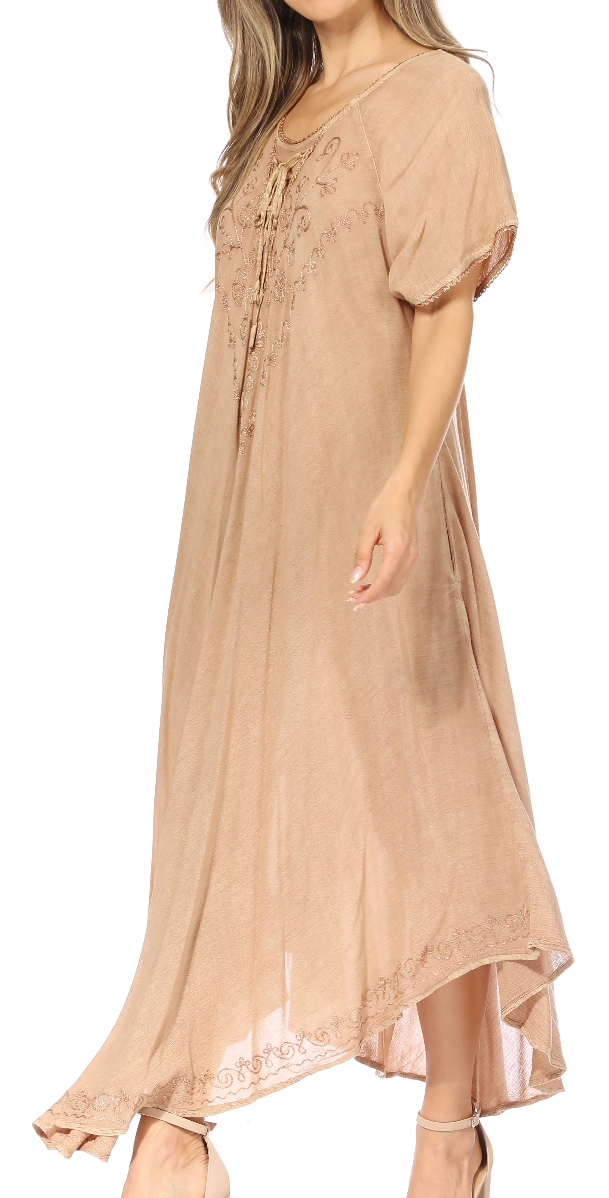 Woman wearing a beige dress with lace details on a white background