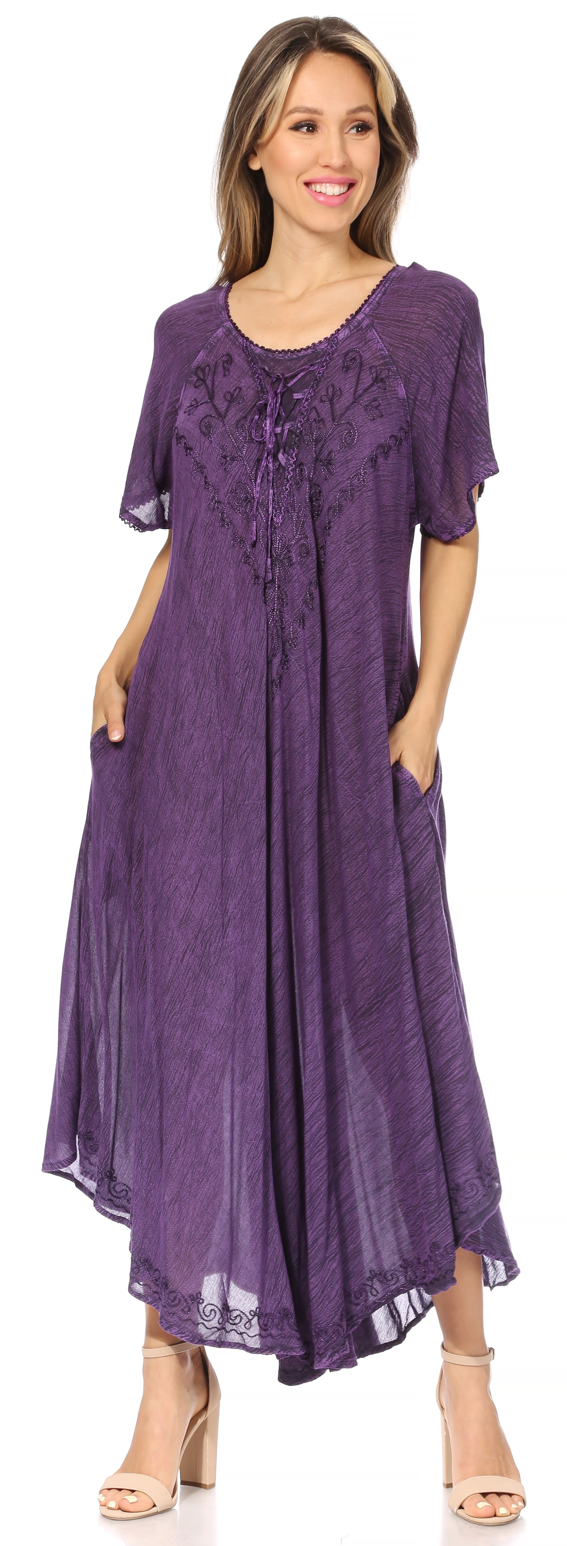 Woman wearing a purple dress with a plain background