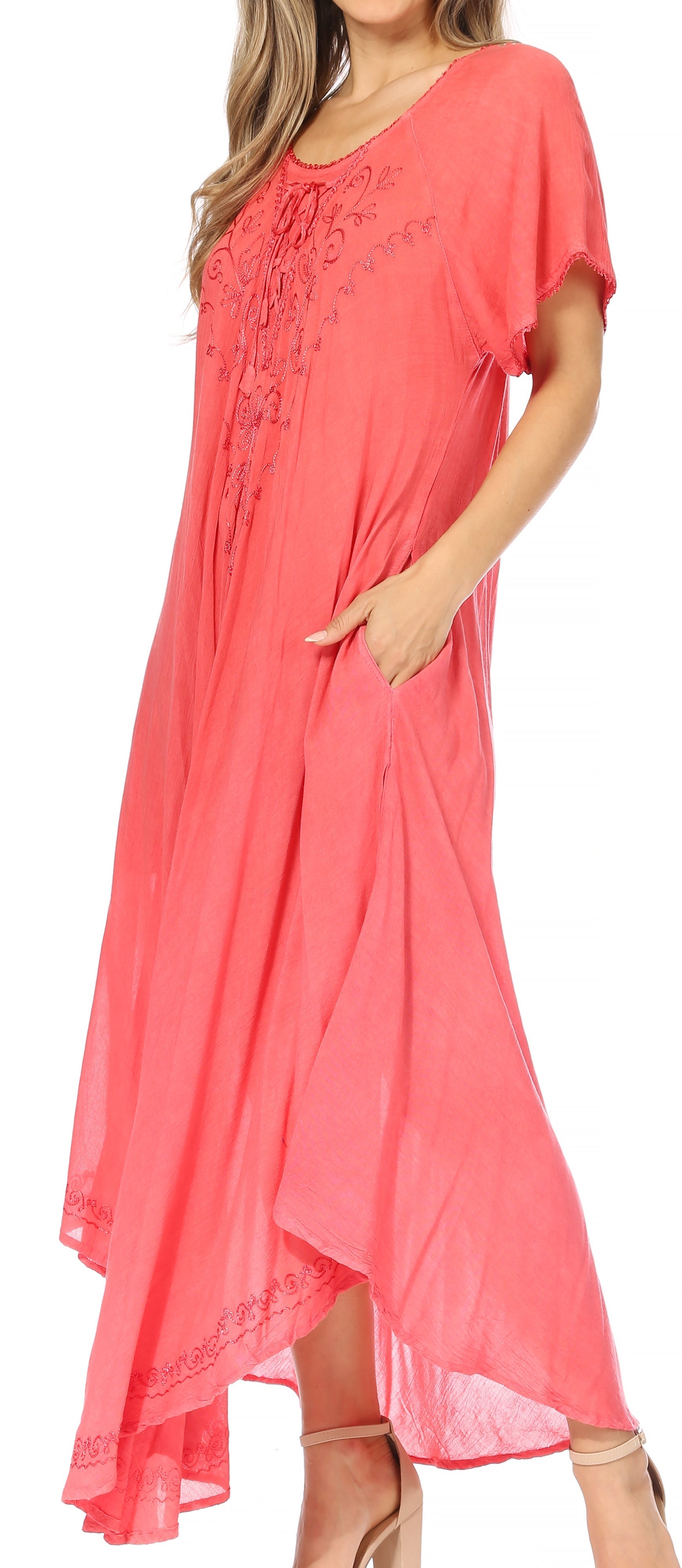 Coral dress with floral embroidery on a white background