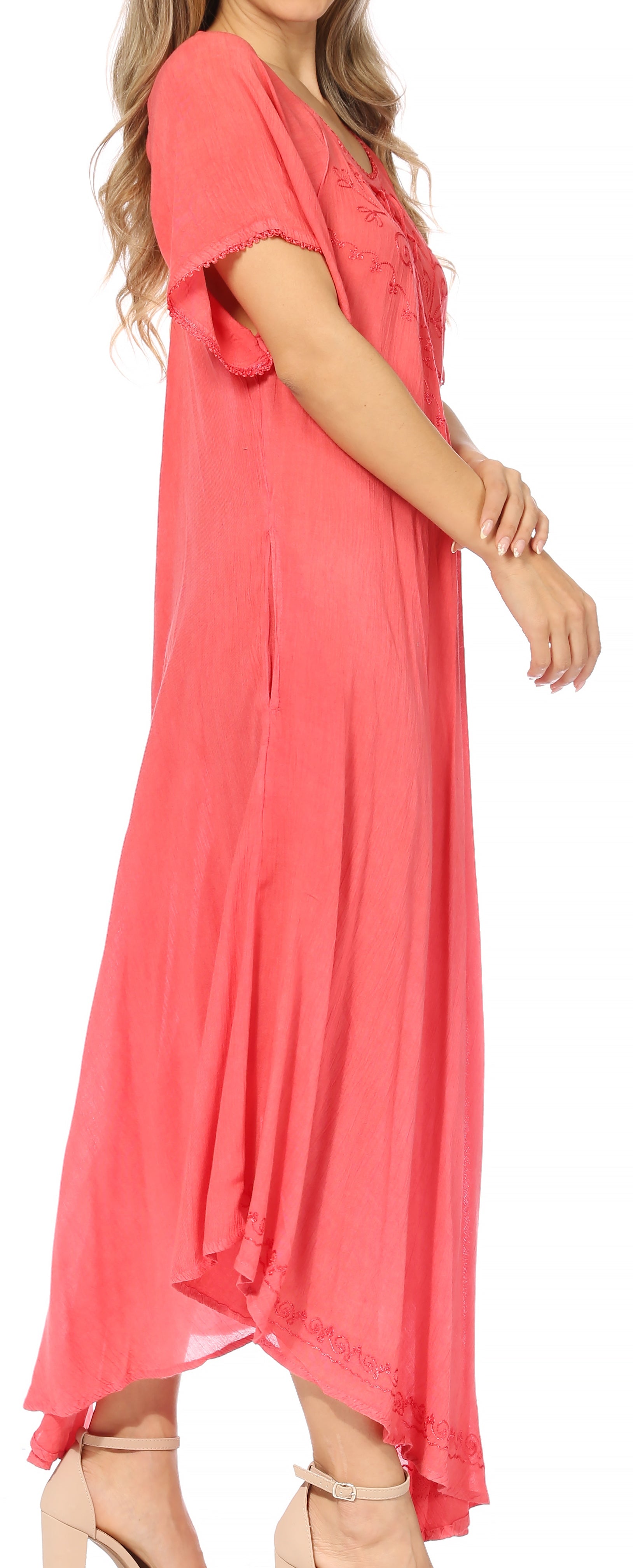 Woman wearing a coral pink dress with a plain background