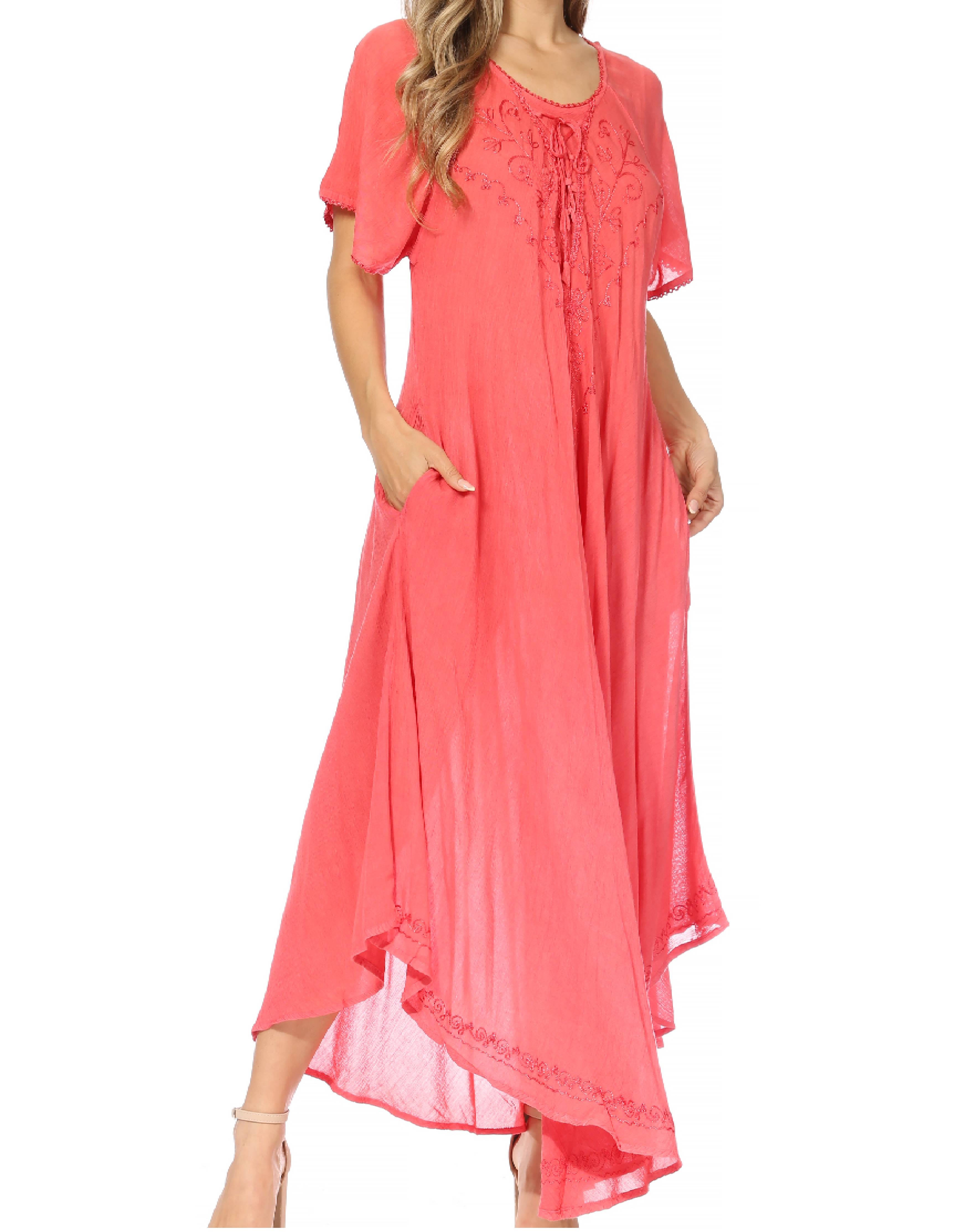 Woman wearing a coral pink dress with lace details on a white background