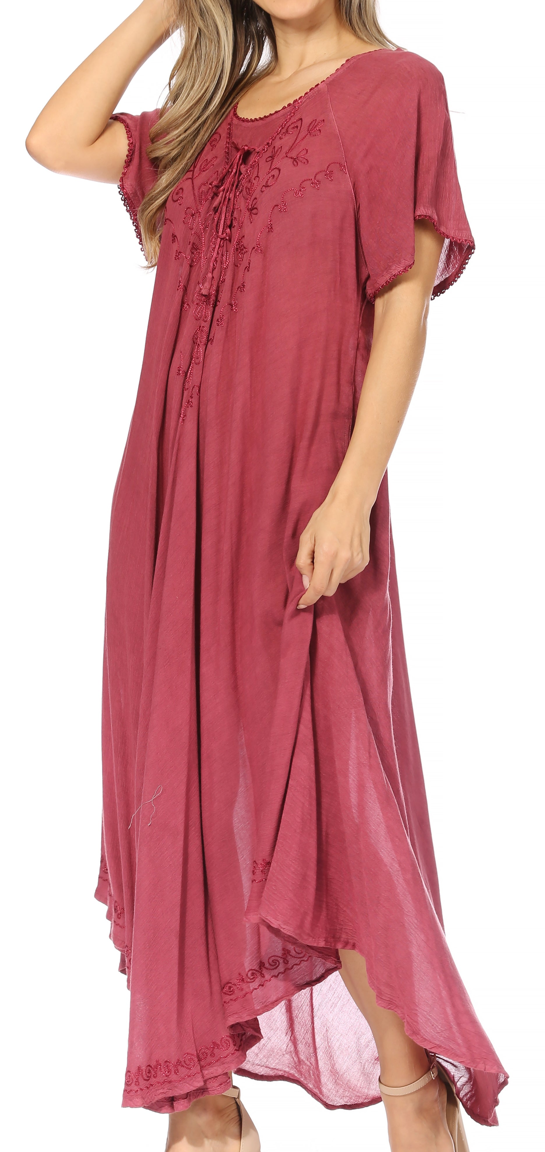 Woman wearing a burgundy dress with lace details on a white background