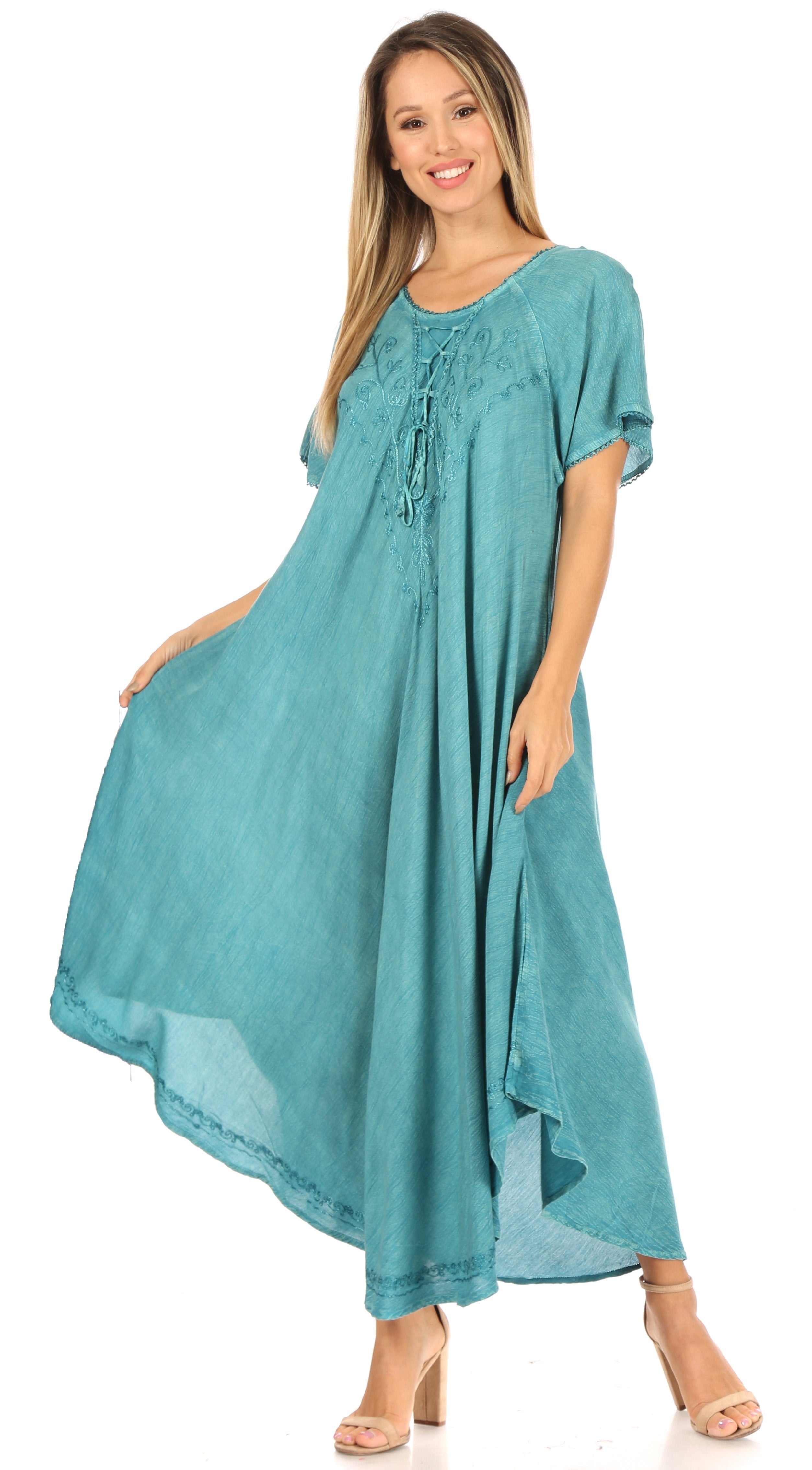 Woman wearing a teal dress on a white background