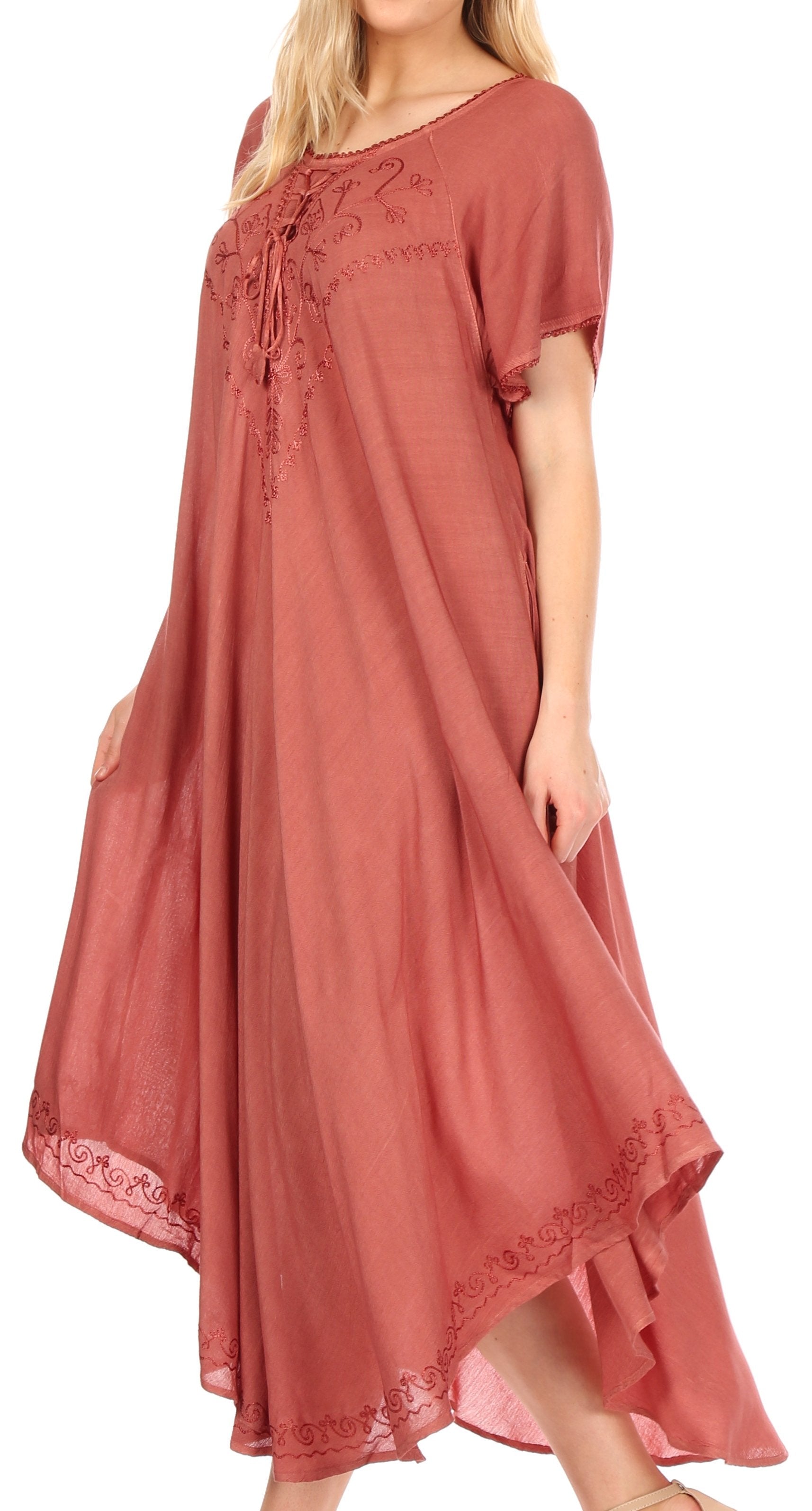 Coral-colored dress with lace details on a white background