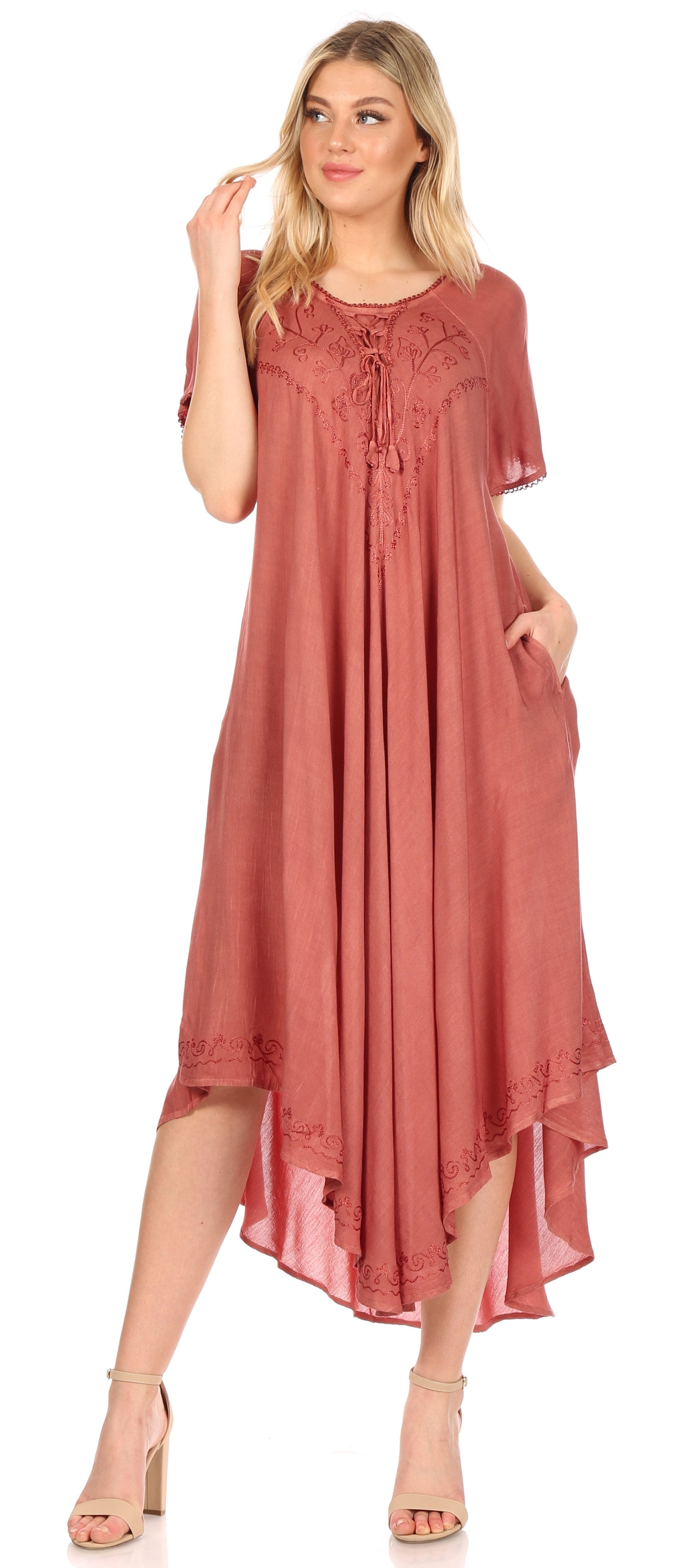Woman wearing a long, flowing dress with a high-low hem on a white background