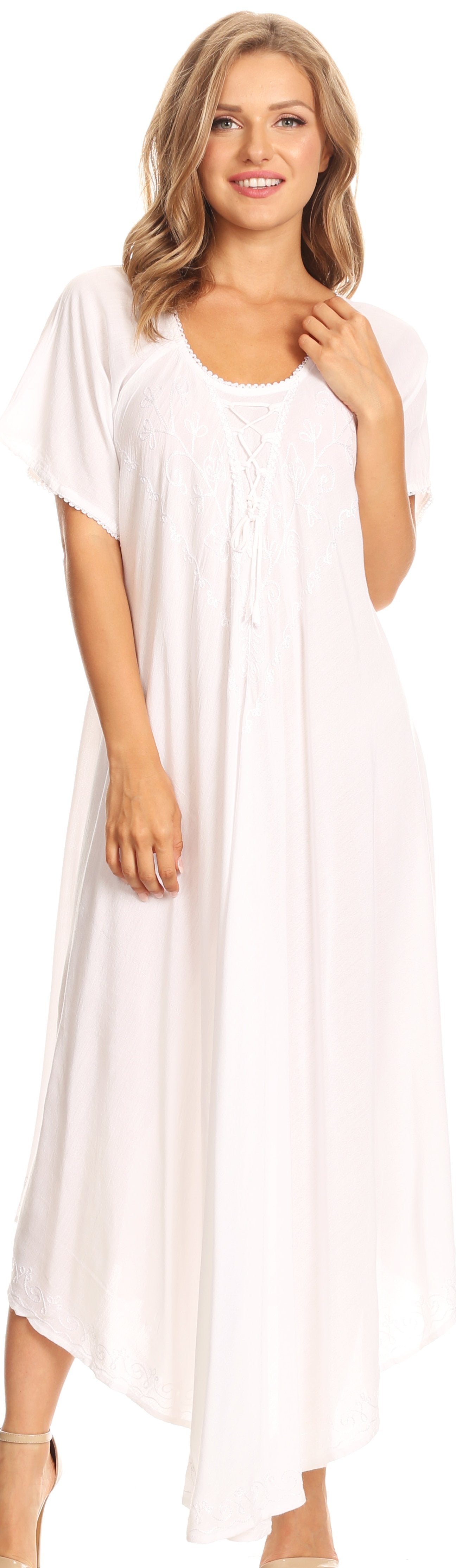 Woman wearing a white dress against a plain background